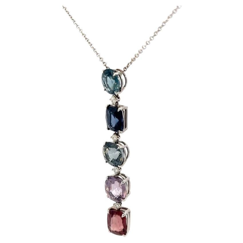 Multi-color, fancy shape spinels weighing 19.39 carats total with small round brilliant white diamonds weighing 0.20 carats in an 18 karat white gold pendant necklace. Each gemstone is a unique fancy shape, with great luster and fire. 
The beauty of