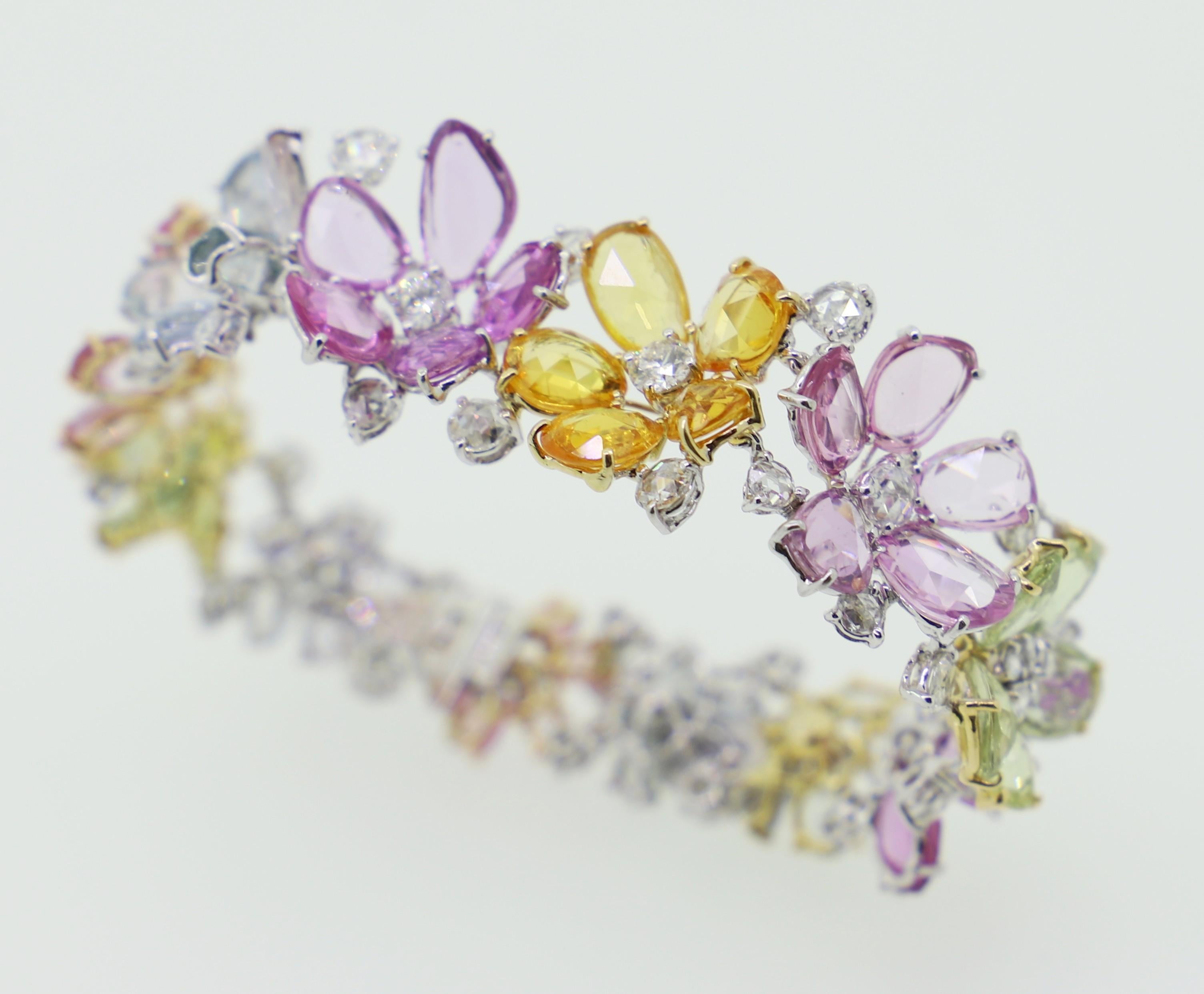 Designed to celebrete the freshness and lightness of Spring, this colourfull Sapphire and Diamond Cuff Bracelet sparkles with the colours of the rainbow.
The Rosecut Sapphires represent delicate Flowers, centred by White Diamonds.
In this entirely
