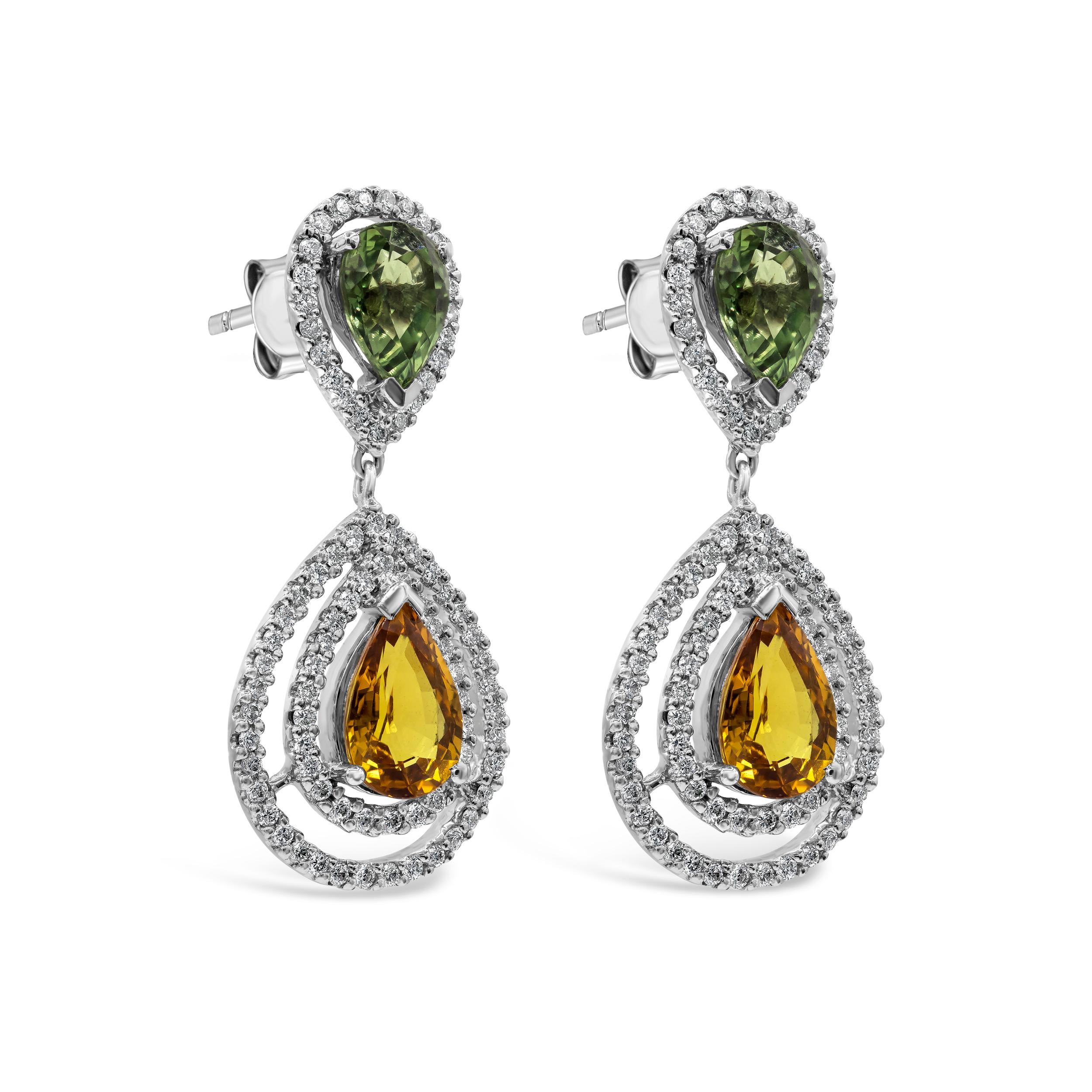 Each earring features a color-rich pear shape orange sapphire, set in an open-work double halo design. Suspended on a green pear shape sapphire halo. Sapphires weigh 6.15 carats total; diamonds weigh 0.92 carats total. Made in 18k white gold.

Style