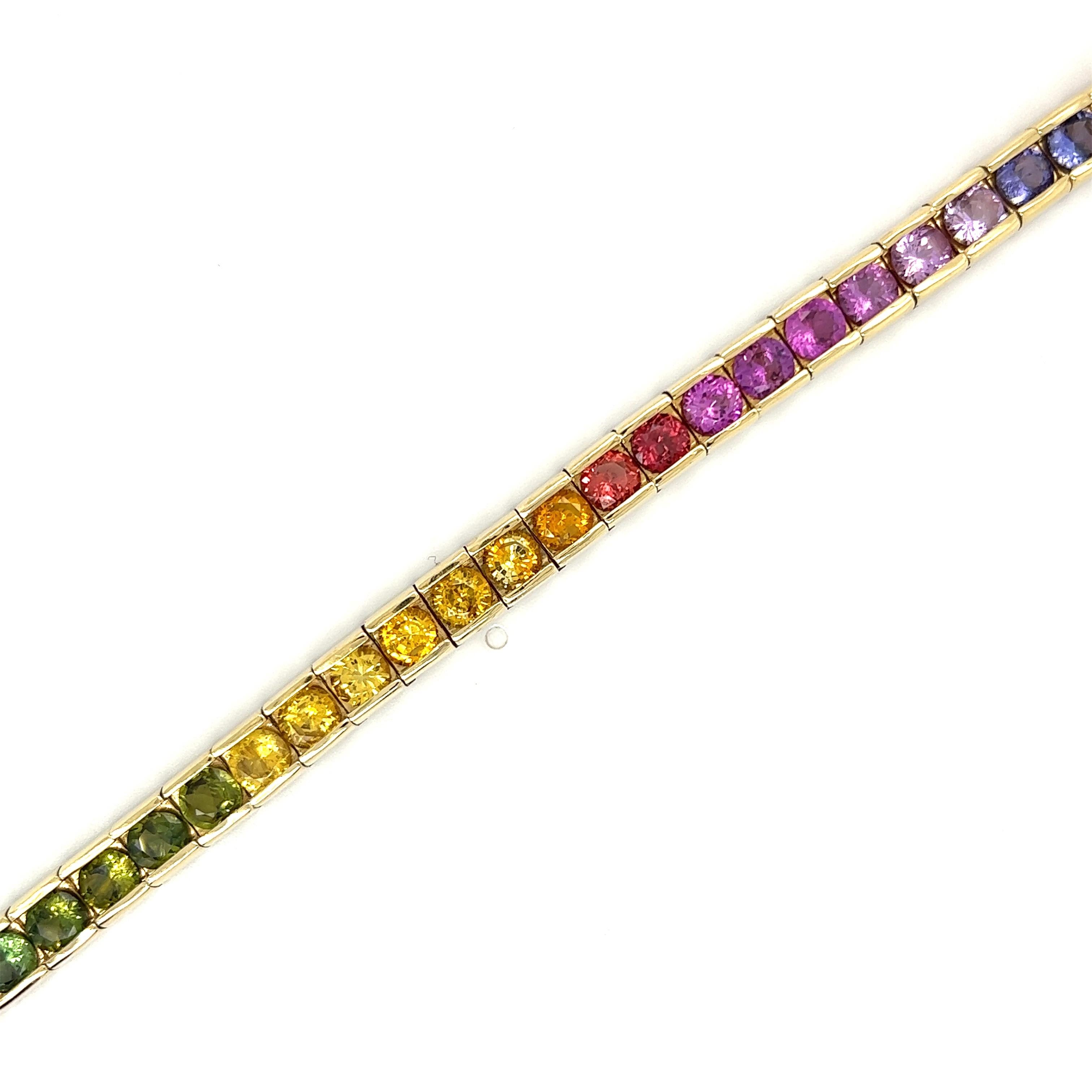 Multi-Color Rainbow Sapphire Tennis Bracelet. Individual Channel Setting. 

Details:

34- Round Sapphire's- 18.80ct Total Weight- Multi-Color
14kt Yellow Gold

