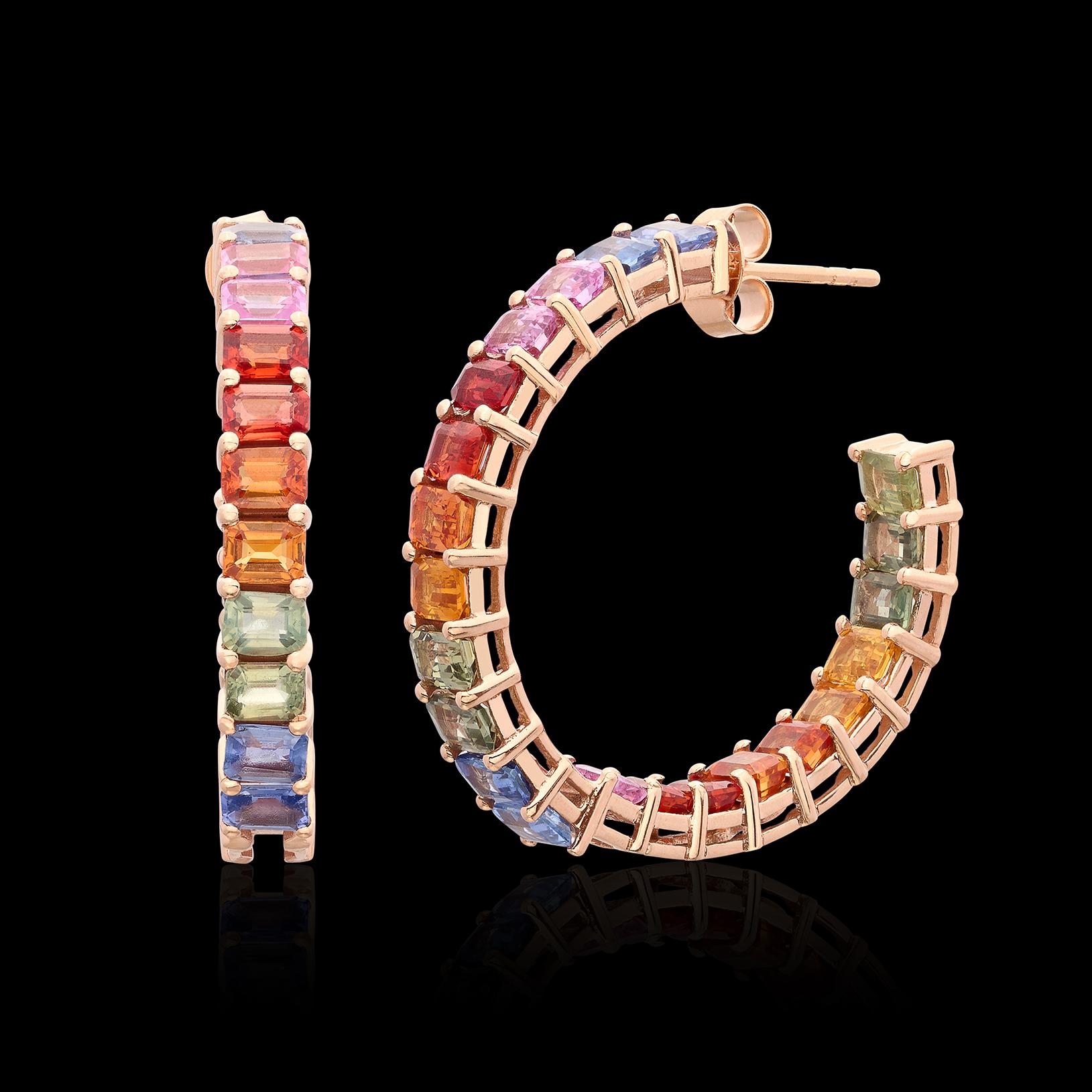 Own these wonderful inside/outside multi-color sapphire hoop earrings, and never be bored! Set in 14k rose gold, the hoops are designed  with 44 rectangular-cut sapphires, in the rainbow of colors, from blue to pink, to orange, to green and yellow,