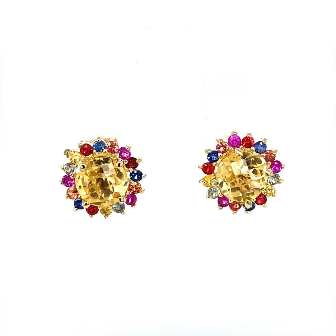 These earrings have 2 beautiful checker board cut Citrines that weigh 1.51 carats and are surrounded by Multi Color Sapphires that weigh 0.68 carats. The stones are set to create a Flower Petal design. The total carat weight is 2.19 carats.  
Made