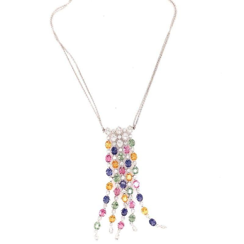 One multi-color sapphire and diamond 18K white gold pendant enhanced with oval sapphires totaling 12.80 ct. and accented by diamonds totaling 1.25 ct. Flexible dangle portions. Circa 1980s.

Vivid, showy, designer.

Additional information:
Metal: