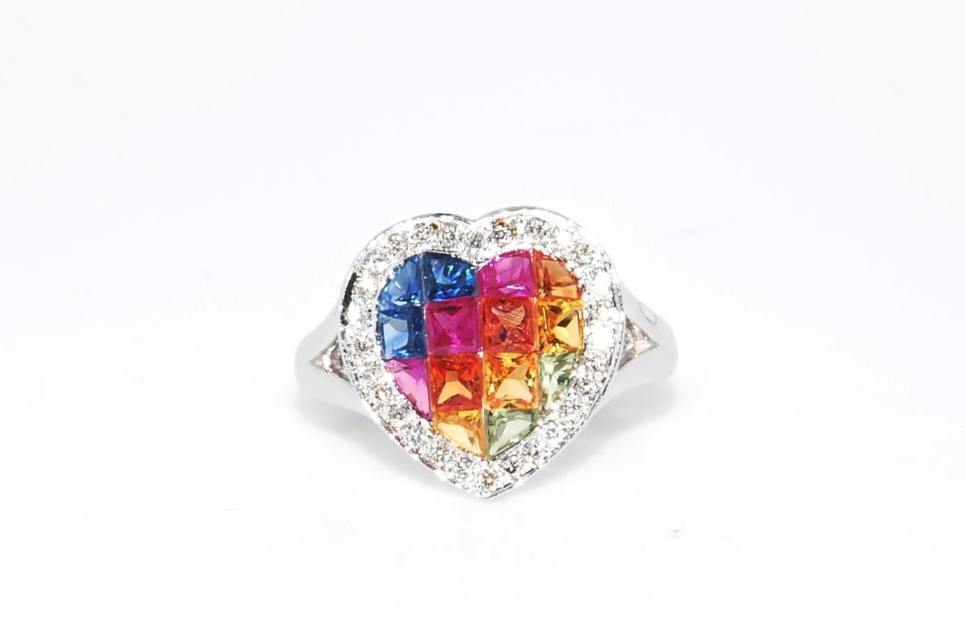 A fun multi-color sapphire ring, heart shaped and set in 5 grams of 18 karat white gold, and inside a 15 point diamond halo. (0.15ctw) 