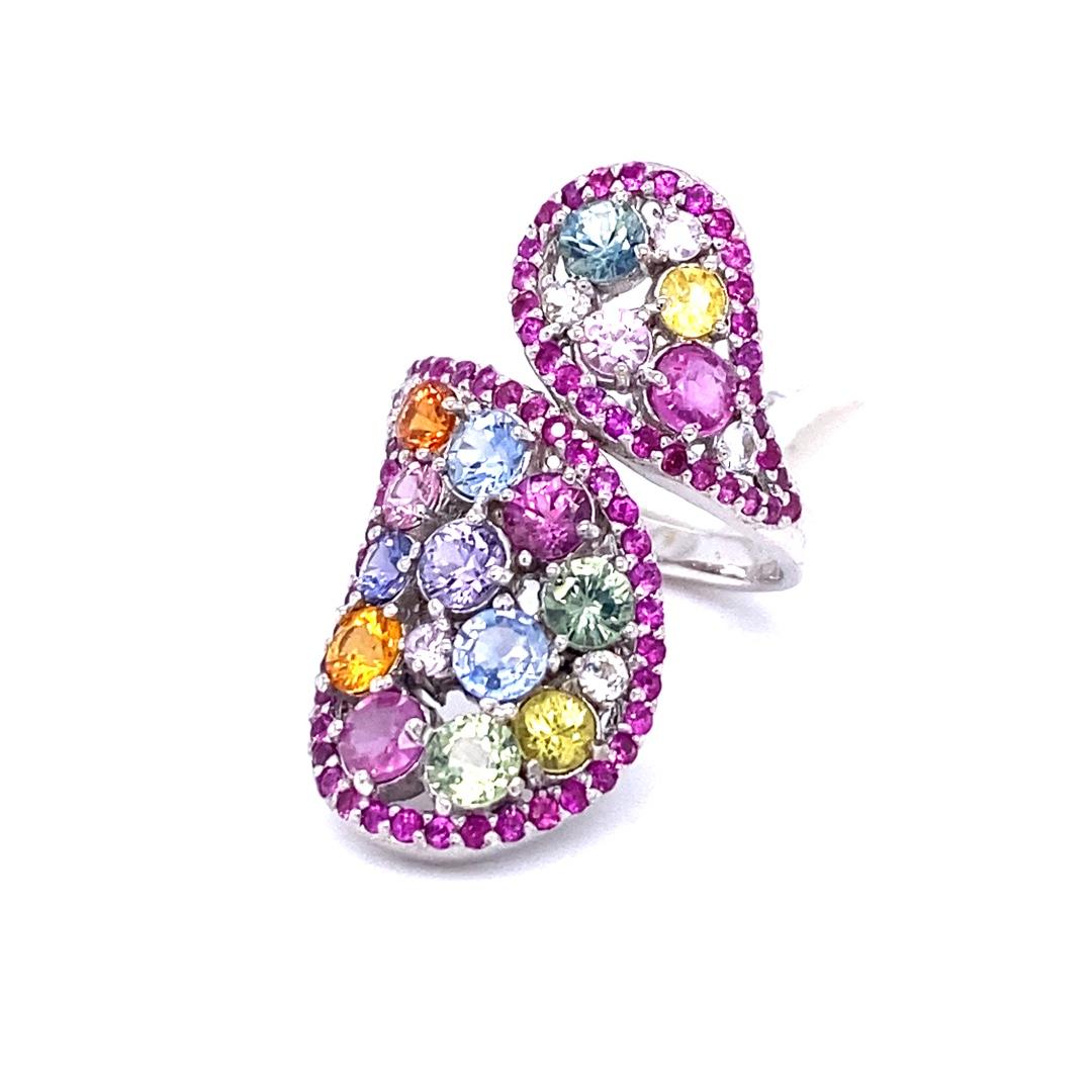 Super gorgeous and uniquely designed 5.31 Carat Multi Color Sapphire 14 Karat White Gold Cocktail Ring!

This ring has a cluster of 16 Round Cut Multi Color Sapphires that weigh 4.11 carats and 73 Pink Sapphires that weigh 0.87 carats. It also has 6