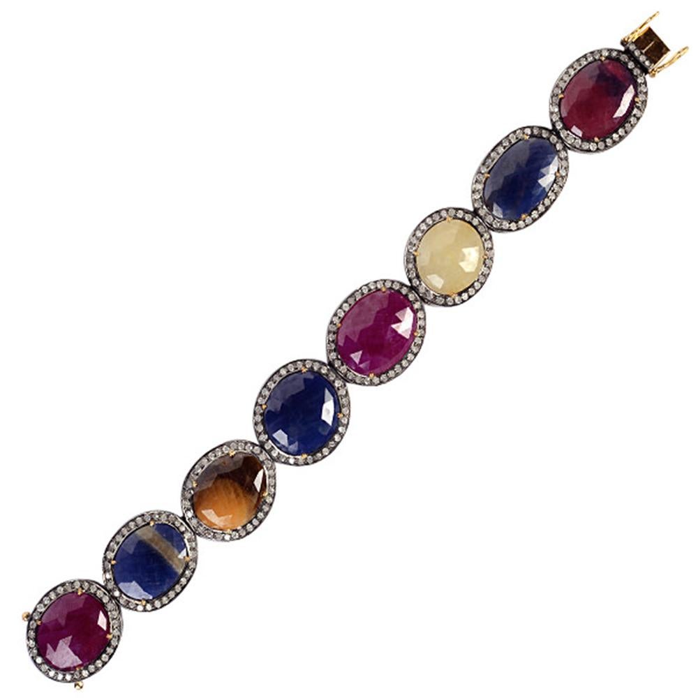 Oval Cut Multi Color Sapphire and Ruby Tennis Bracelet with Diamonds Set in Gold & Silver For Sale
