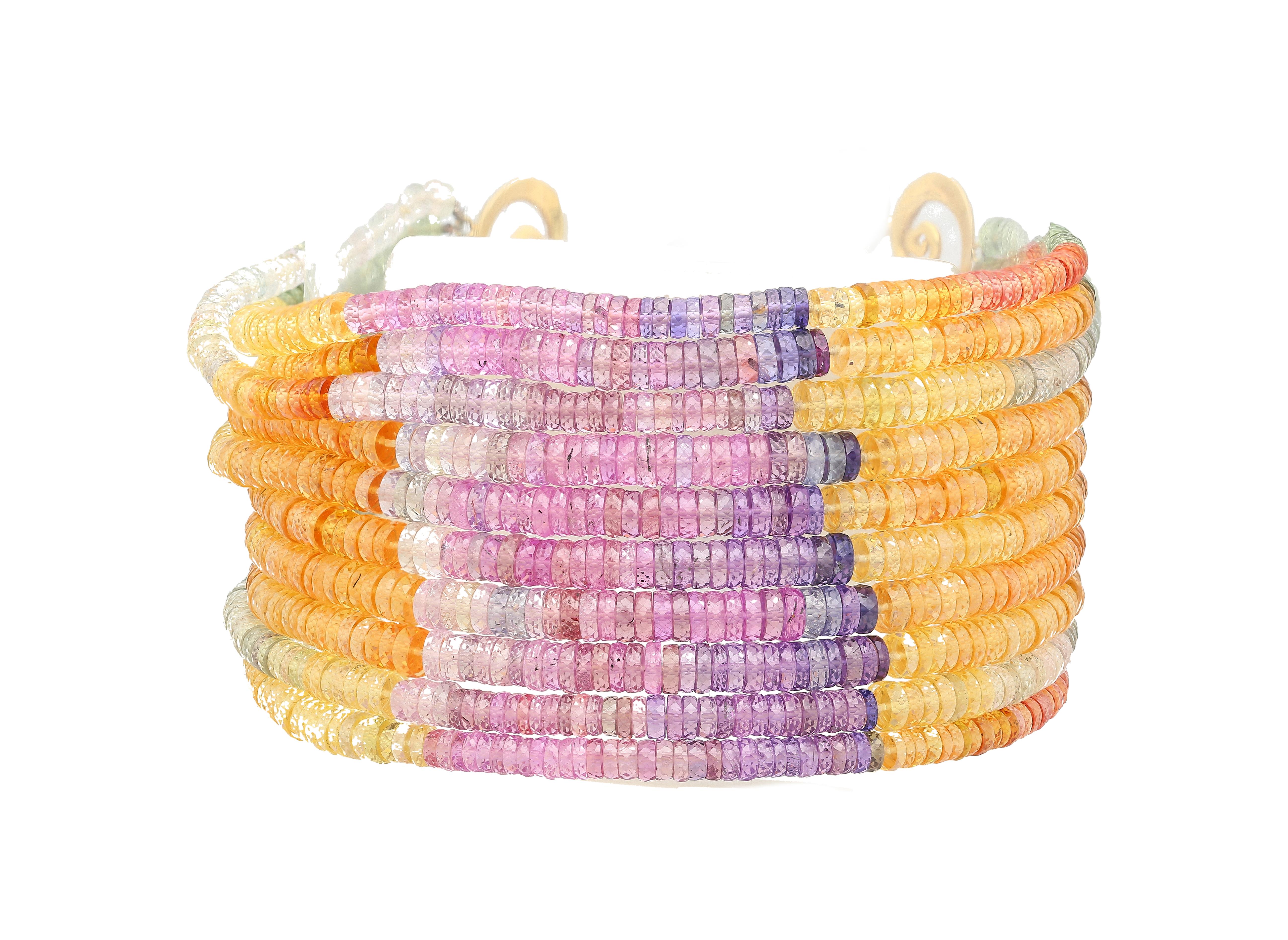 Multi-color Sapphire Bead and Diamond Bracelet in 18K Yellow Gold. A rainbow themed natural sapphire and diamond bracelet that hugs the wrist and dazzles with color.

This beaded bracelet features 10 strands of multi colored sapphires. Paired with