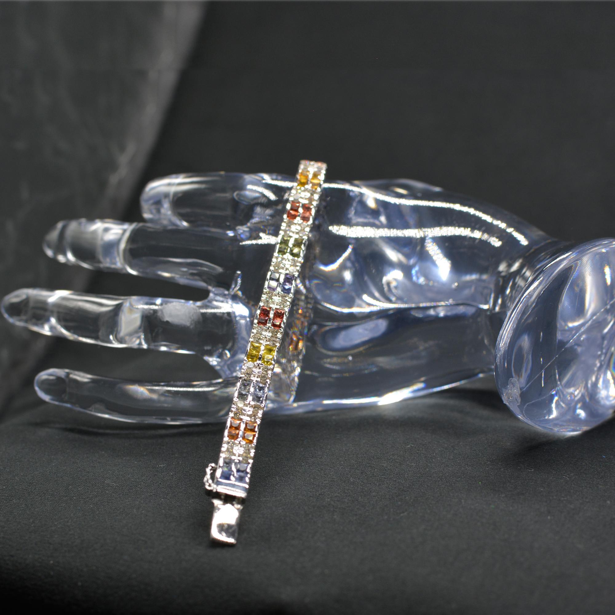Brilliant Magnificent,
Multi color Sapphire Bracelet AAA Quality Sapphires Princess -cut shape, Total of 6.00 carat. 
Round Diamonds total of 3.00 carat  GH -SI.
14K White Gold 27.0 Grams.
Length 7' Inch.
Bracelet width is approx. 6.5 mm
