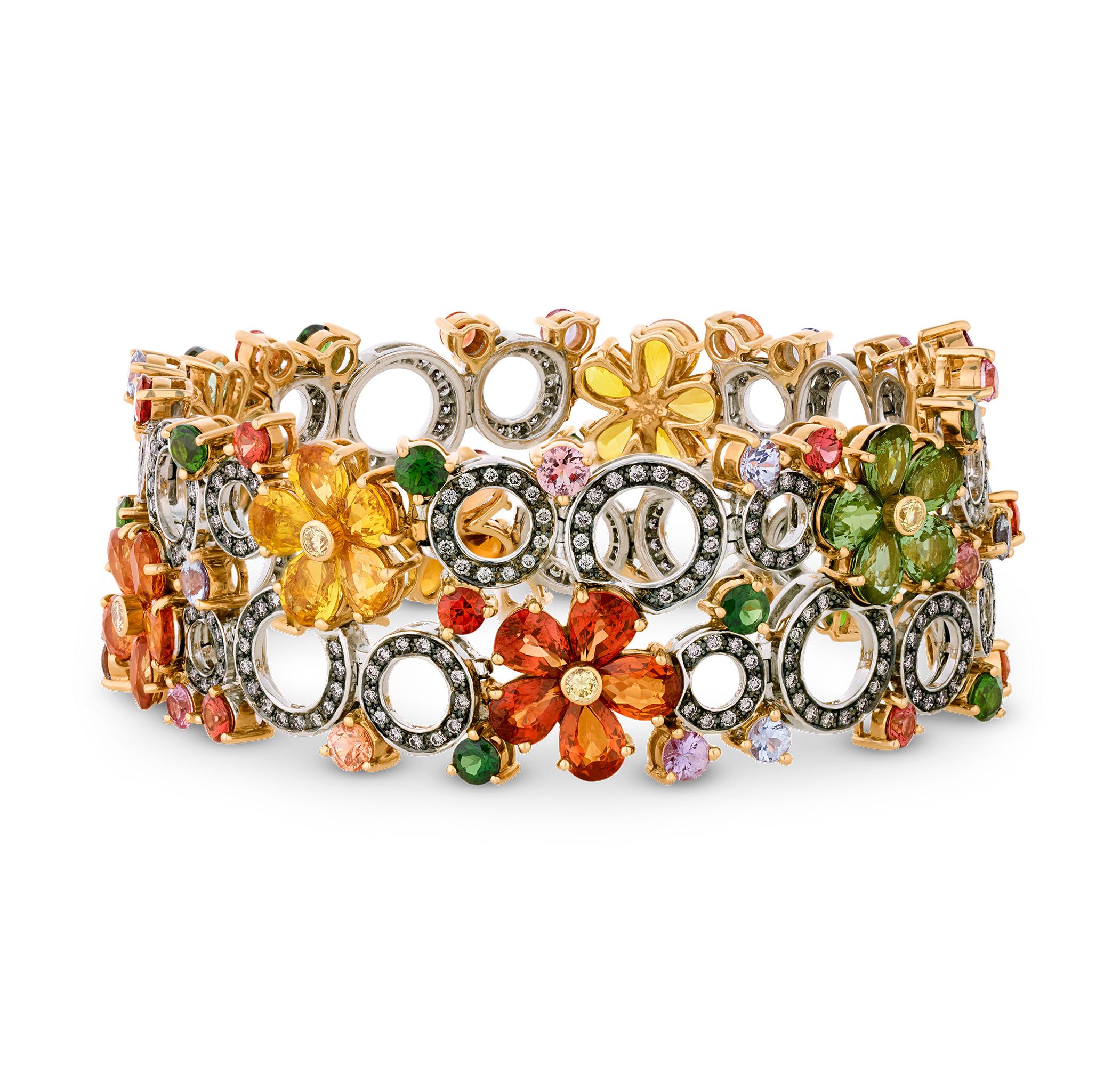 Displaying a vibrant garden bursting with the color possibilities of sapphire, this remarkable bracelet showcases a dazzling composition of pear and round shaped fancy sapphires arranged as floral blooms. The spectrum of color includes yellow,