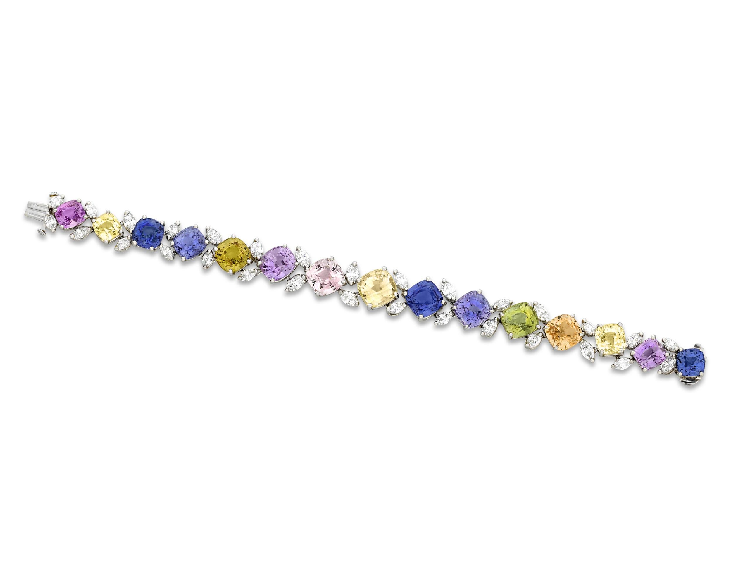 Fifteen stunning cushion-cut sapphires, ranging in color from traditional blue to pink, purple, orange and yellow, present a sparkling rainbow of hues in this bracelet by the celebrated Oscar Heyman. The multi-colored gemstones total an incredible