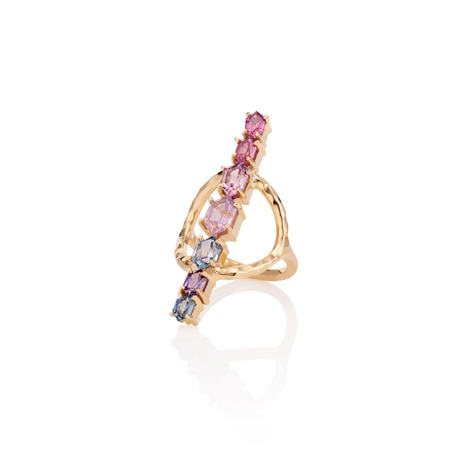 This Ring is 18 Karat Yellow recycled  Gold. It is detailed in approximately 5 Carats of multi-colored Pinks and purple-hued Sapphire. Each stone has been custom-cut by hand to give the stones a unique and one of a kind feel. The total length of the