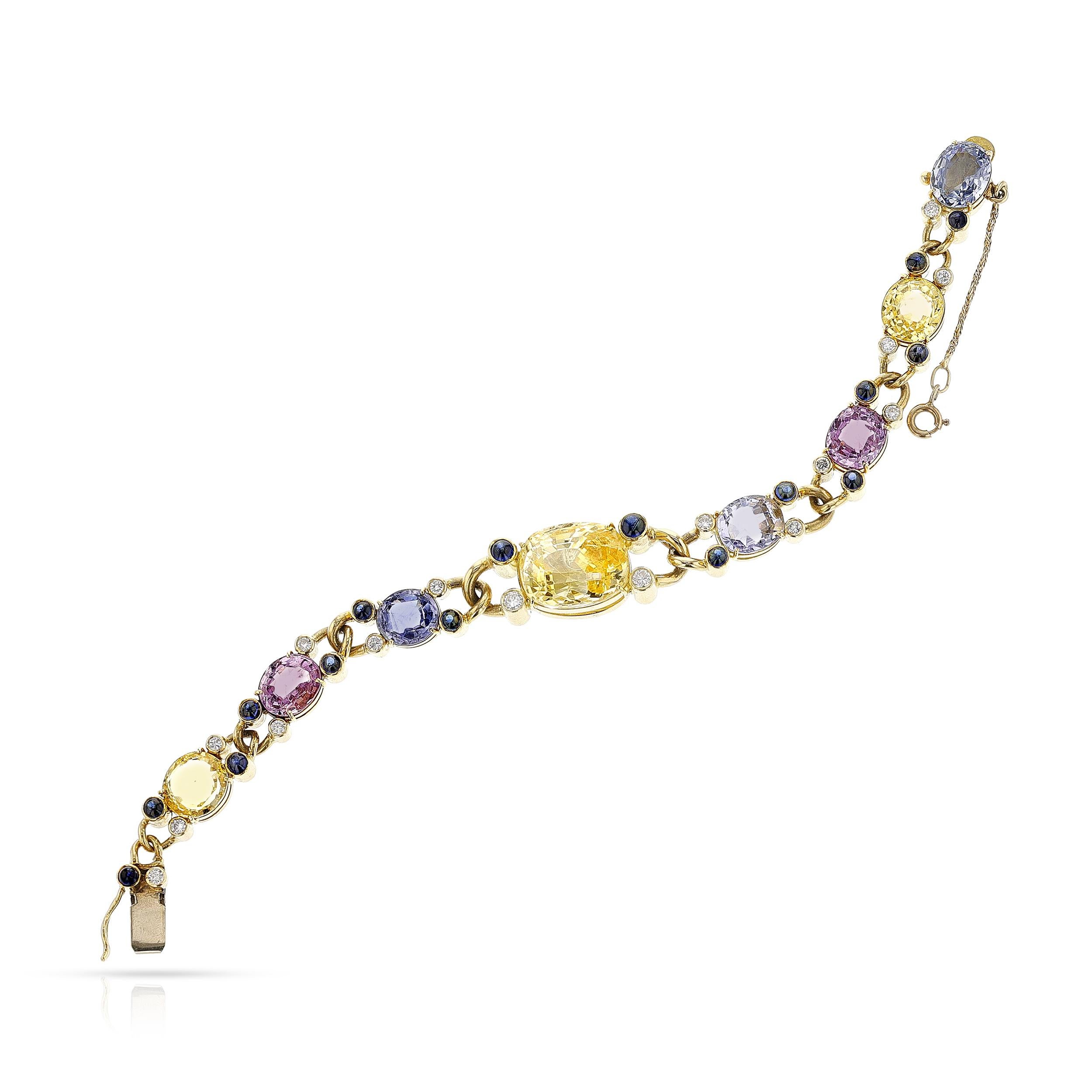 Multi-Color Sapphire Cut Stones and Cabochon with Diamond Bracelet by Deaken & Francis London made in 18k Yellow Gold. One oval
yellow sapphire is appx. 14.00 cts., 7 oval yellow, blue and pink sapphires appx. 21.00 cts., 15 round cabochon