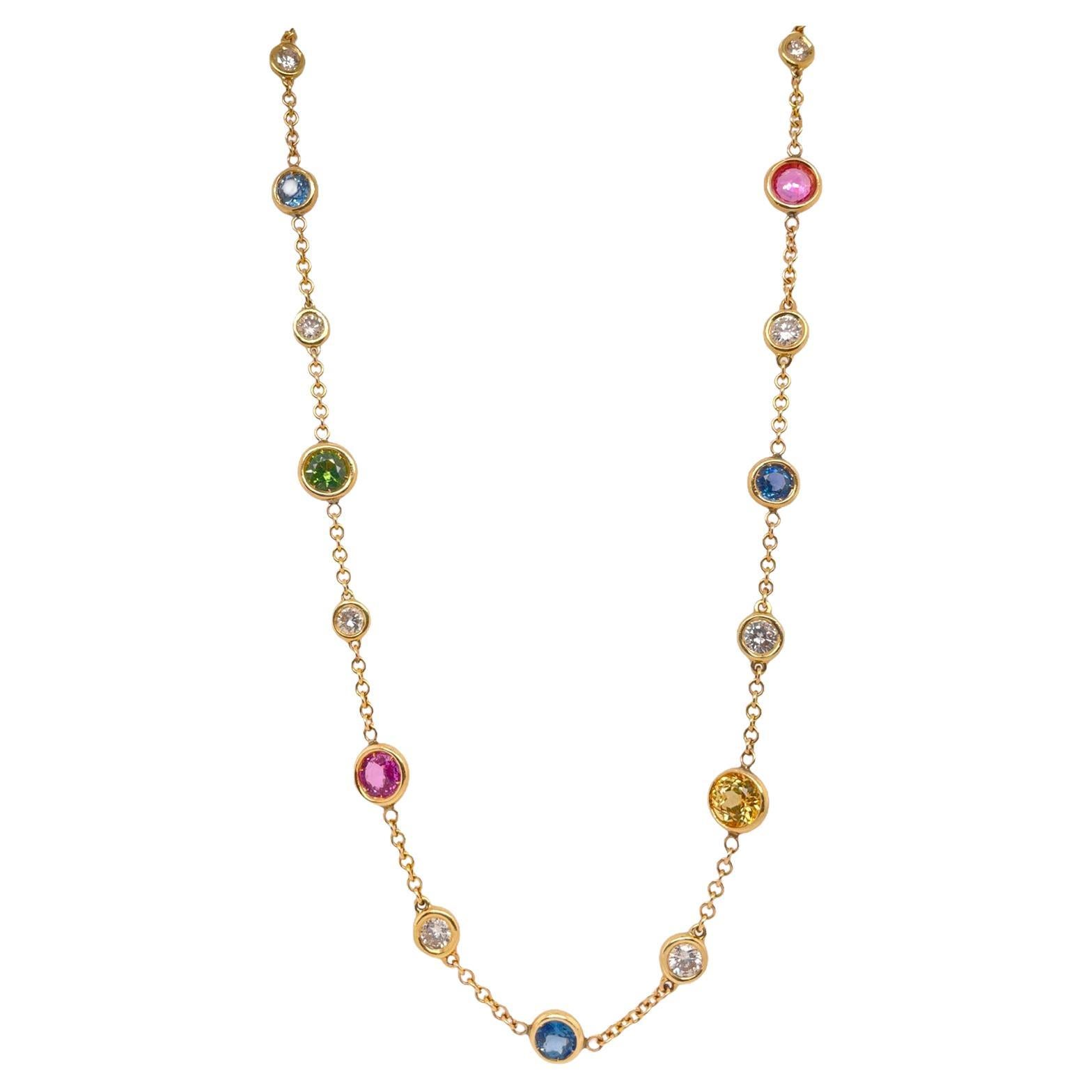Multi color sapphire and diamond bezel set necklace in 14k yellow gold. Necklace contains round brilliant multi colored sapphires, 7.85tcw and round brilliant diamonds, 2.80tcw. Diamonds are near colorless and SI1 in clarity. Stones are all mounted