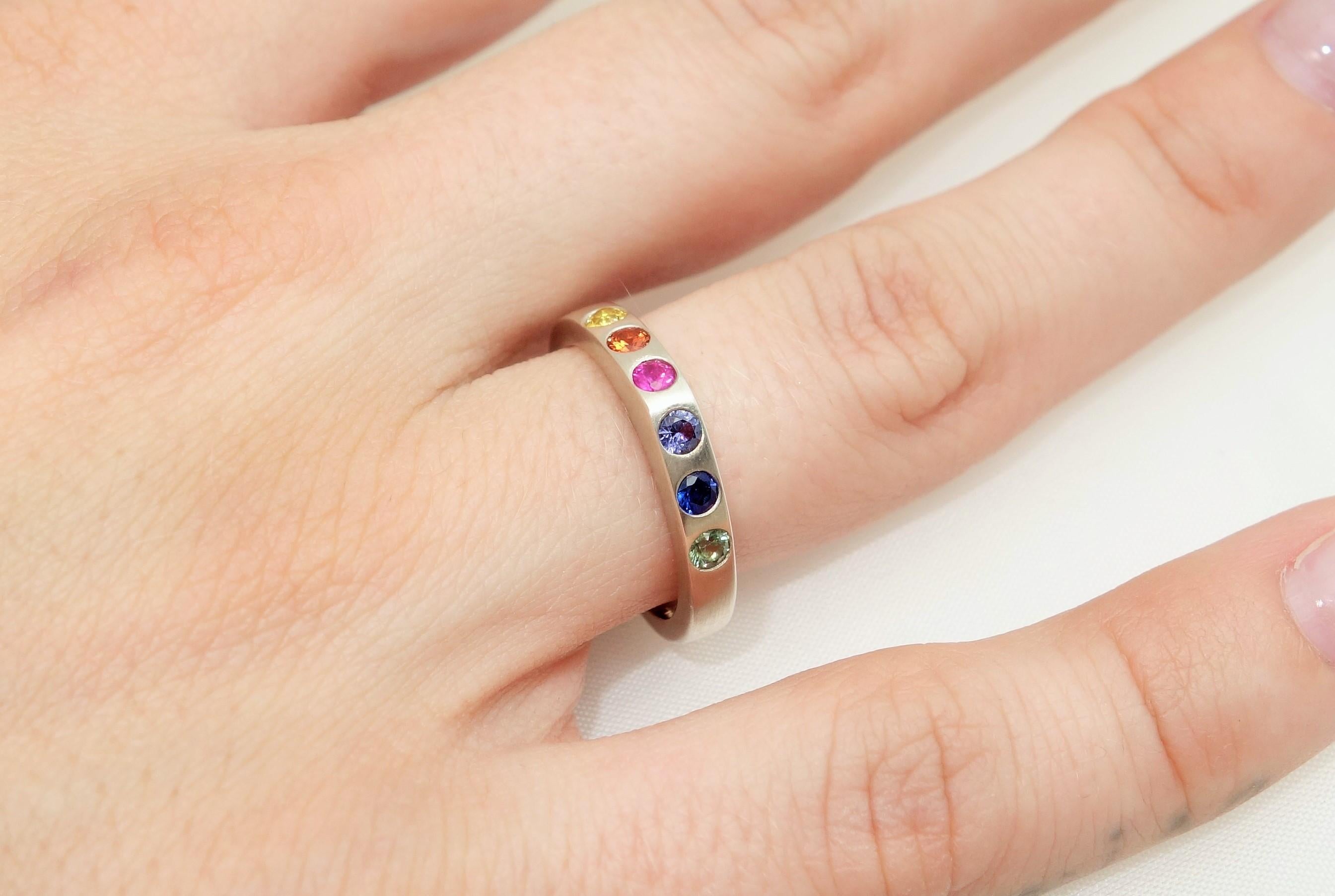 Simply Beautiful Multi-color Sapphire Eternity Band set with .52 Carat, hand crafted in Rhodium Sterling Silver. Ring size 6. Classic and so easy to wear…illuminating your look with Timeless Beauty! 

