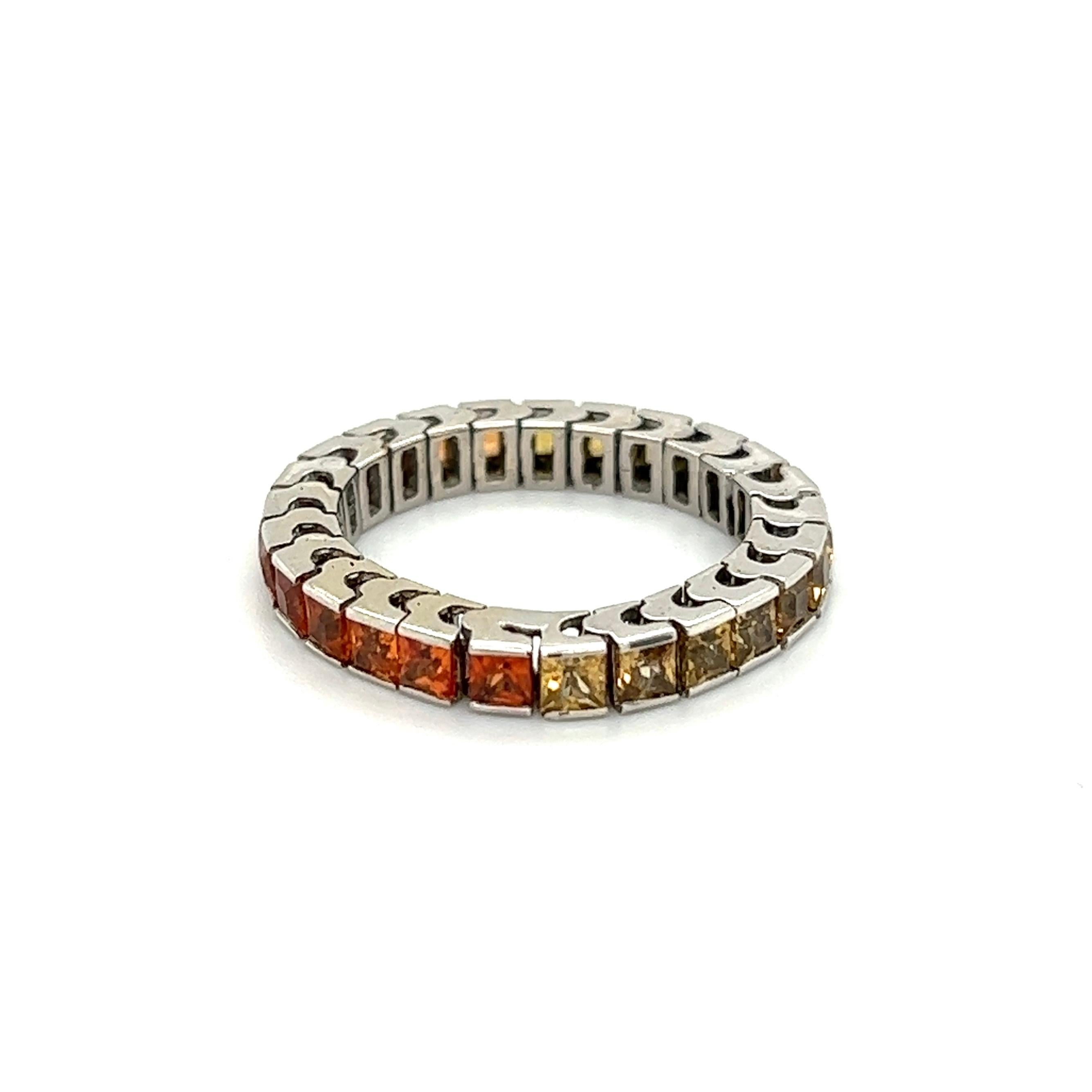 Simply Beautiful Finely Detailed Sapphire Gold Eternity Band Ring. Bezel set with Orange to Yellow Sapphires in Hand crafted 3.2mm Flexible 14K Yellow Gold Band. Measuring approx. 0.91”l x 0.91”w x 0.12”h. The ring epitomizes vintage charm, ideal