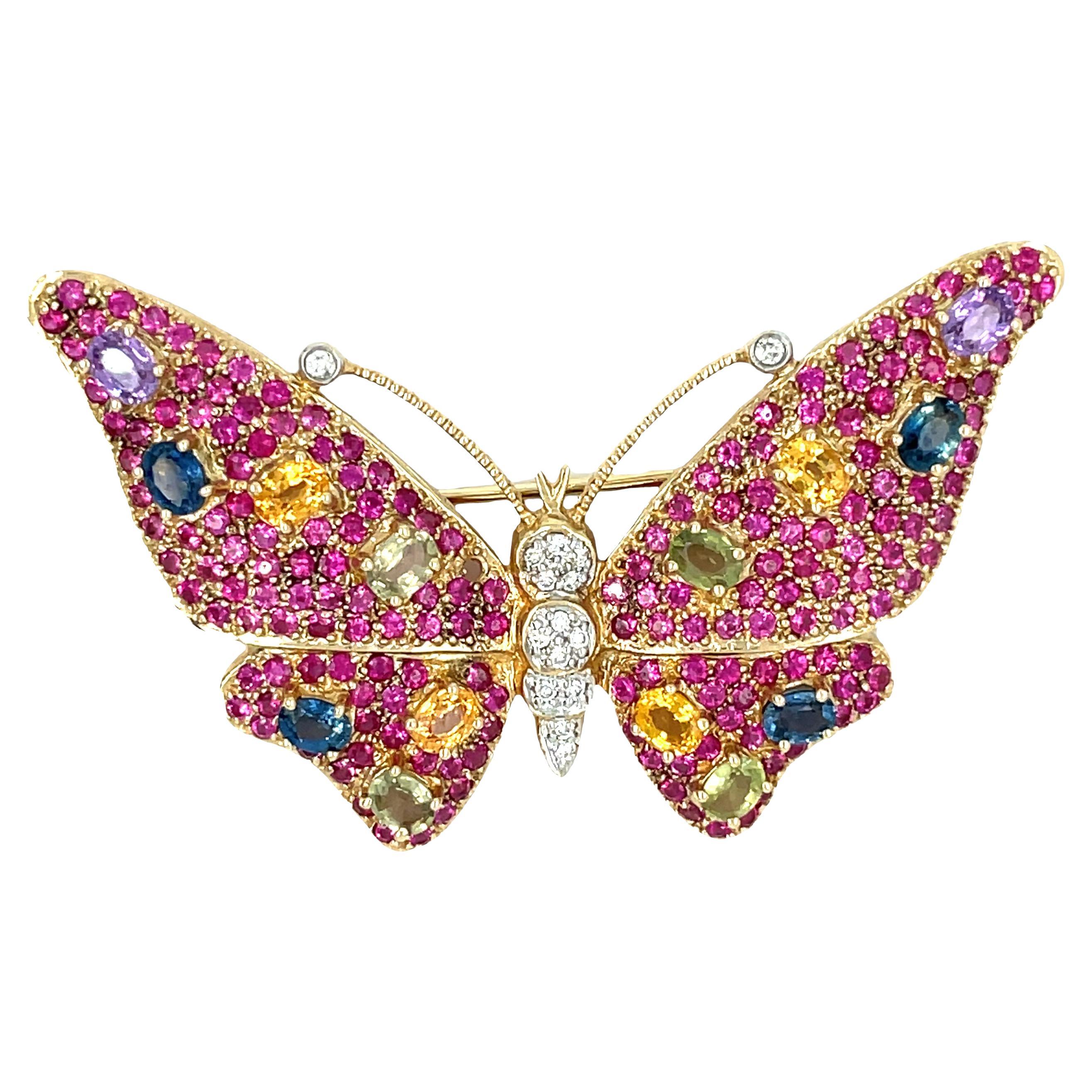 Experience vibrant beauty with this whimsical butterfly brooch adorned with a stunning array of rubies, multi-color sapphires, and dazzling diamonds. A true work of art, this brooch features superb gems totaling 5.5 carats, carefully set in polished