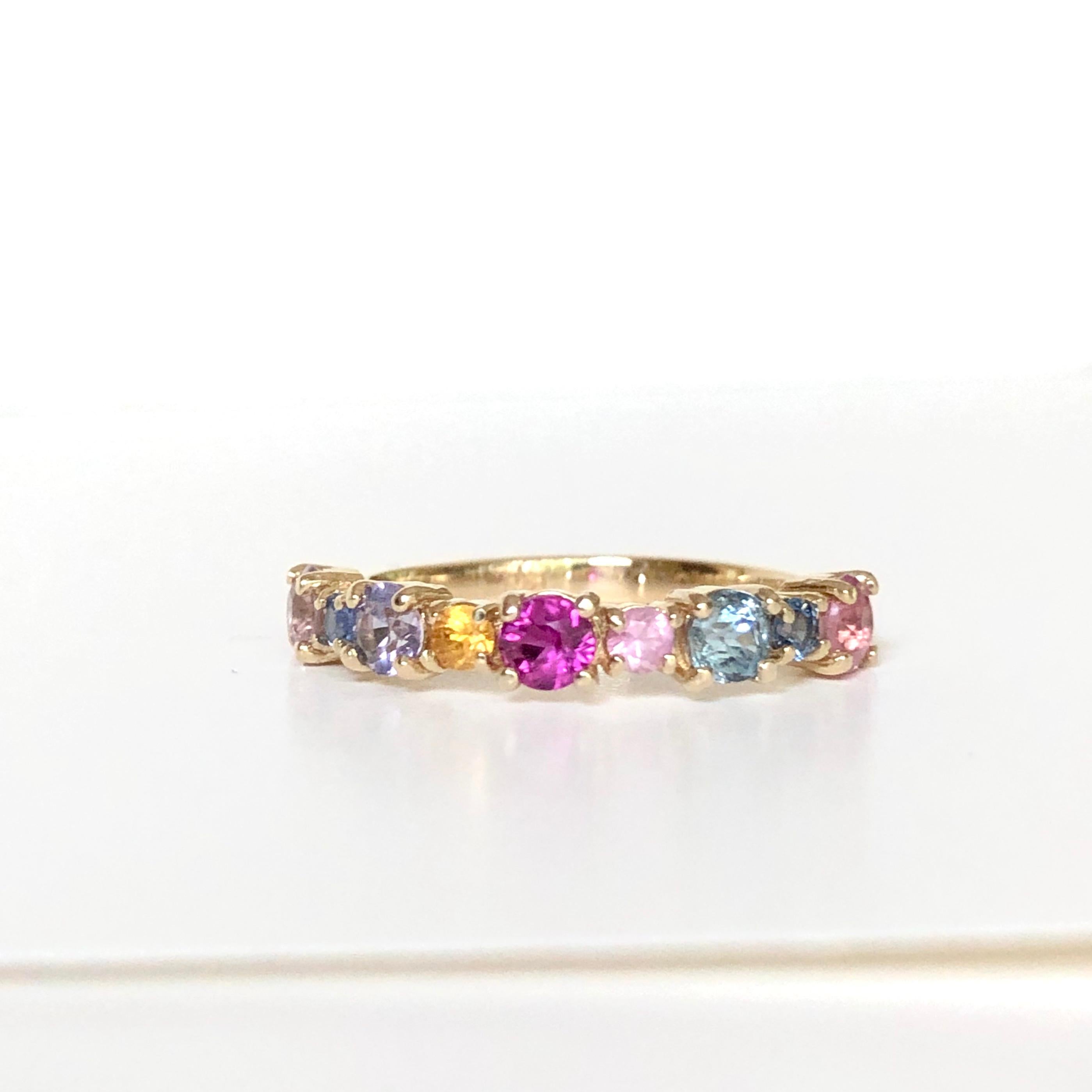 Beautiful round brilliant cut multi color natural sapphire with a half circle of round multi color candy sapphires 100% natural, weighing approx. 1.00 carat. This fabulous band is fashioned in 14K yellow gold mounting and 100% natural