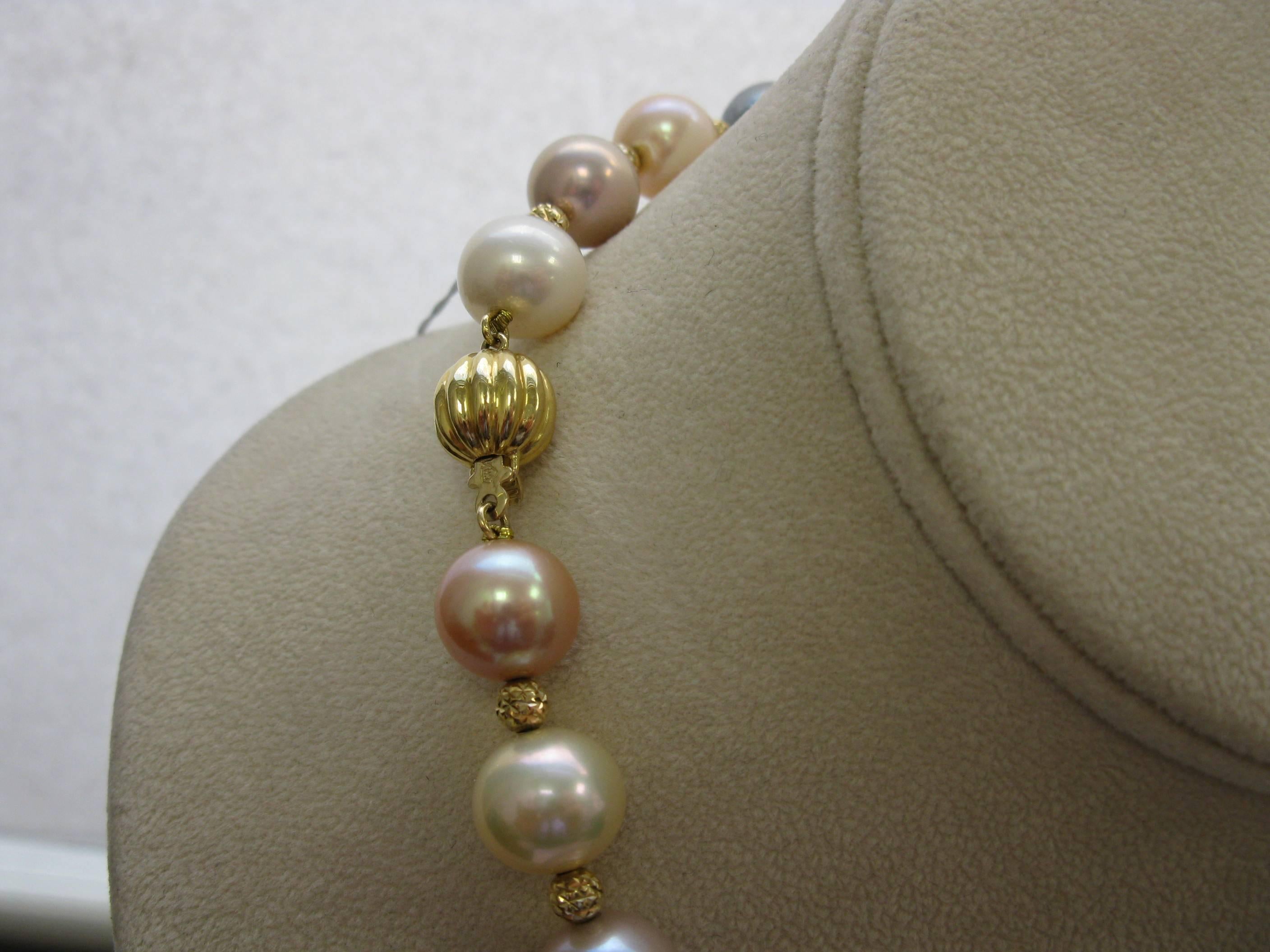 These gorgeous natural colored pearls are slightly graduated. The largest is 14 mm and the smallest, in the back , is 11 mm. Top quality luster. The beads in between are 18 kt gold faceted beads. The clasp is also 18 kt gold and is about 10 mm