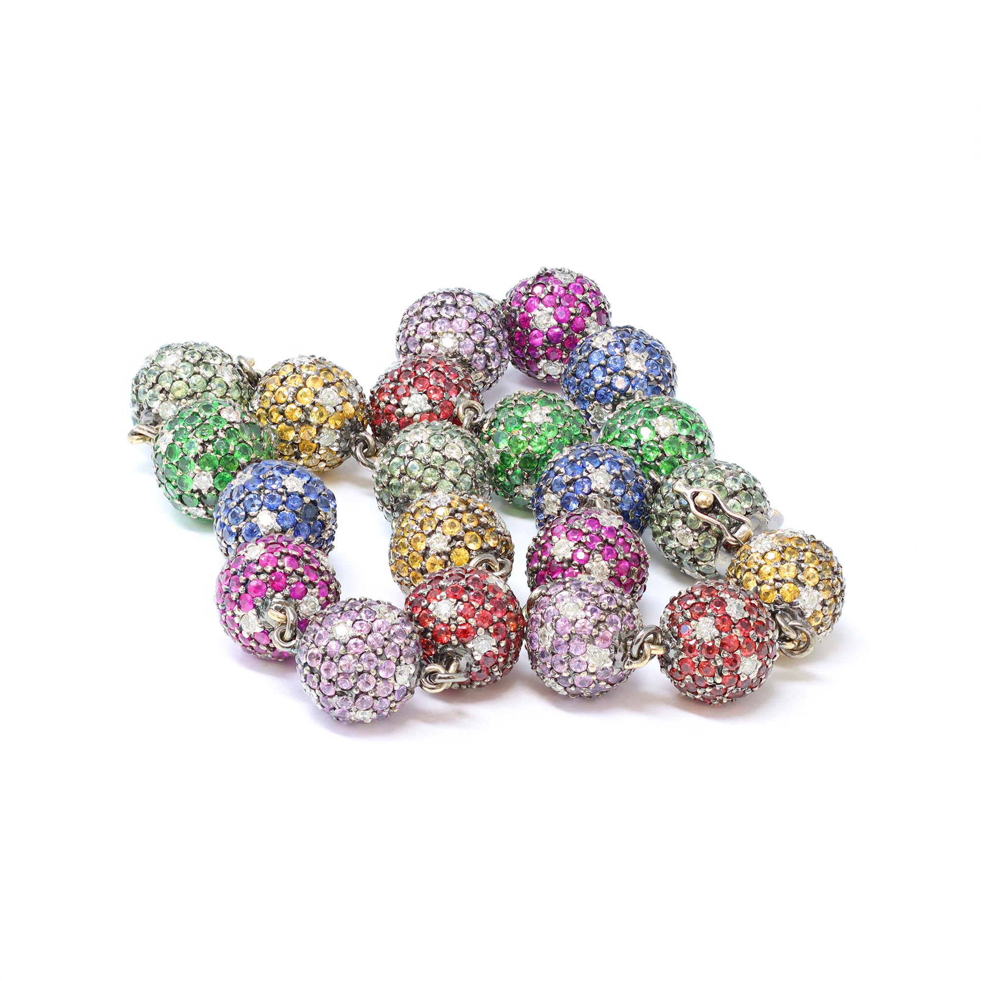 A unique and modern bead necklace featuring multicolor gemstones set in a pave fashion with diamond accents. The necklace has a total of 21 balls including the clasp. Each ball is set with natural stones : Blue sapphires, pink sapphires, rubies,