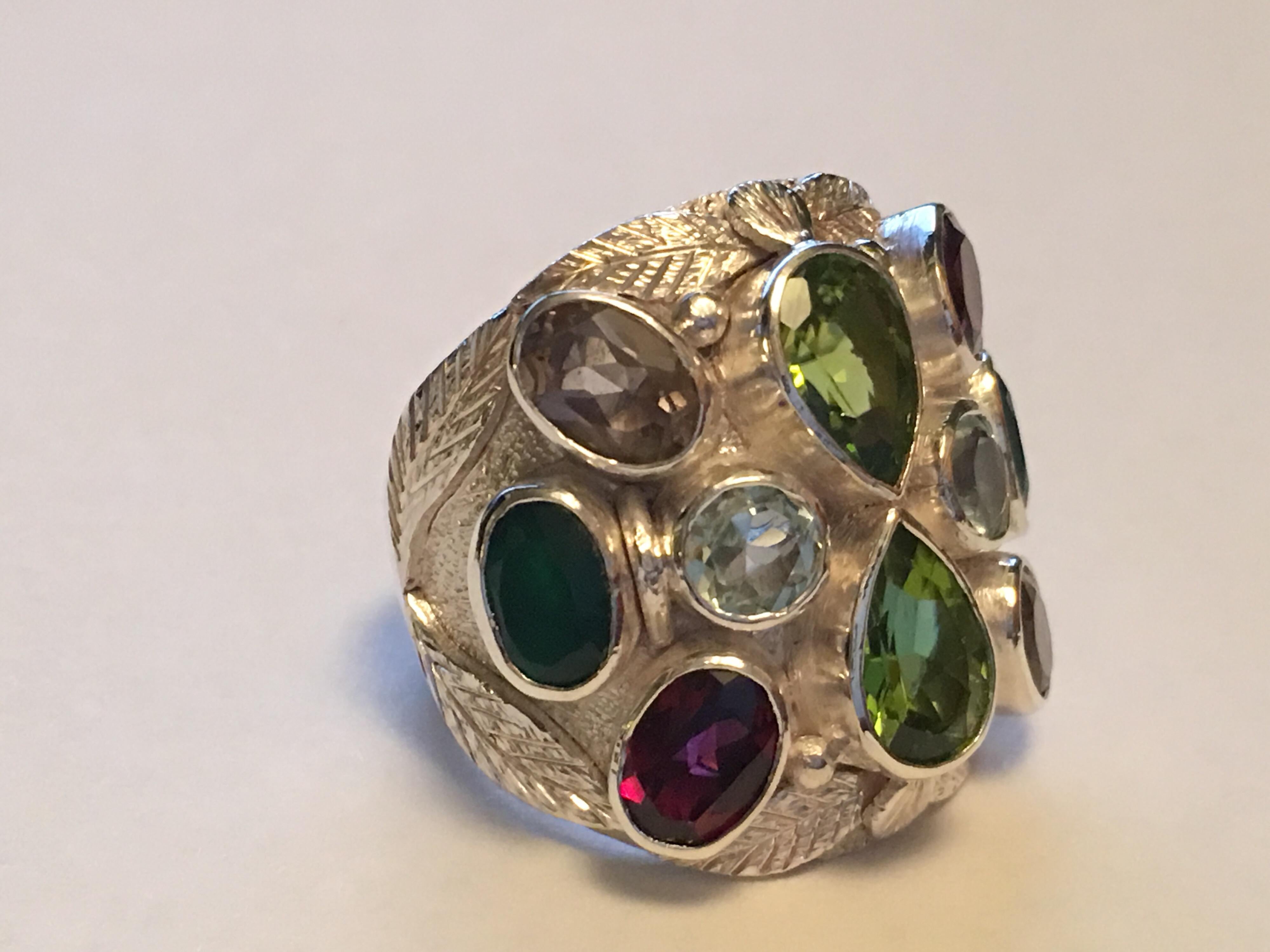 Pears shape Peridot. Oval Garnet, Round aquamarine, Oval  Smokey Topaz, and oval Emerald  are hand cut and polished .
All the stones are natural not heated or treated stones. Hand crafted one of a kind ring IS UNISEX.

Total weight is 19.01 Gram.