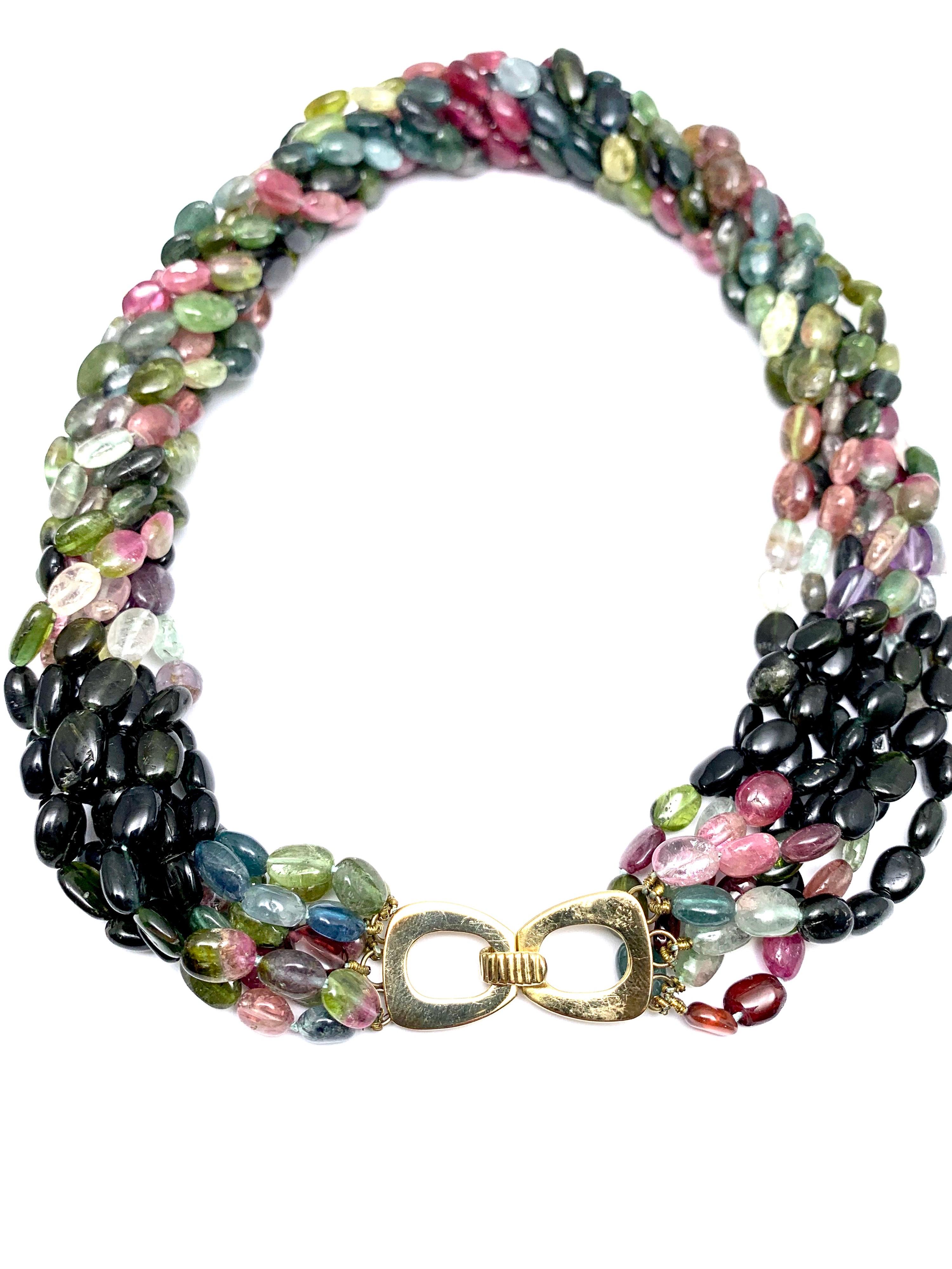 A wonderful multi strand necklace made of a variety of different colored Tourmaline.  The Tourmaline are all smooth oval shaped beads strung on eight strands.  the clasp is a simple slide open and close in 14k yellow gold.  The necklace is 18.50