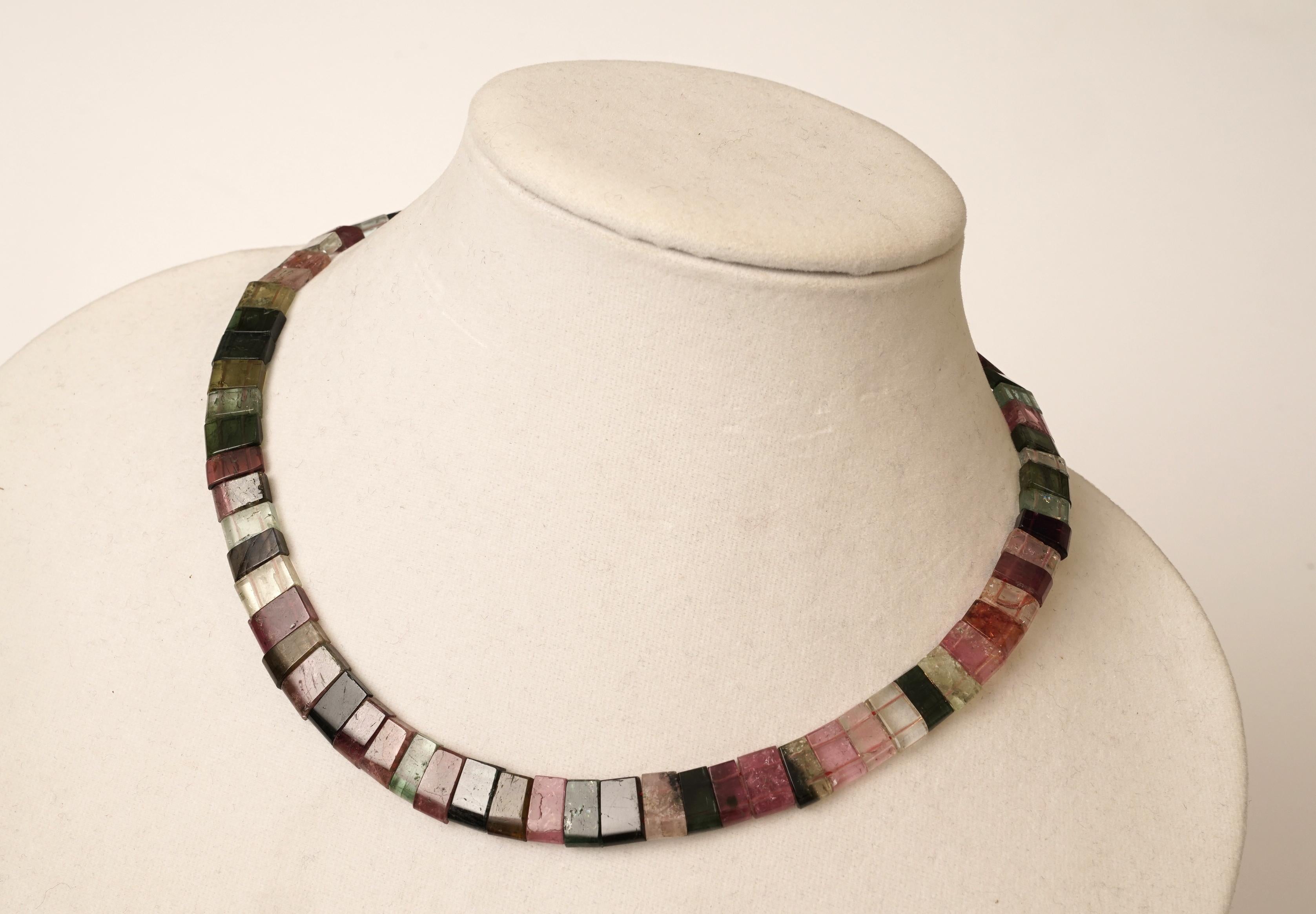 An unusual flat and beveled-cut and slightly wedged tourmaline choker representing the multi colored variations of the stone.  Slightly graduated, all natural.  Sterling silver lobster claw clasp.  