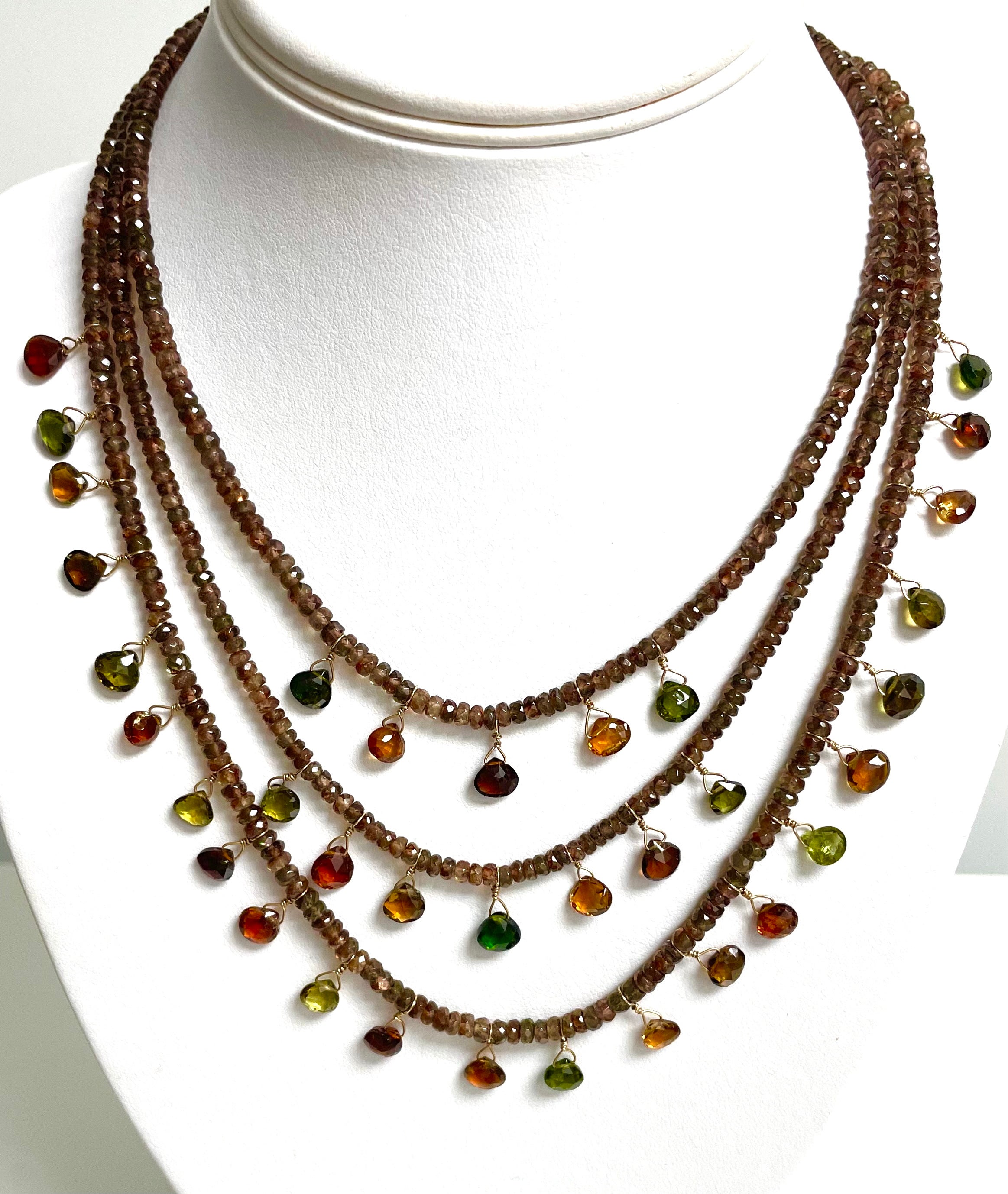 Description
Fall is calling you! These precious little multi-color Tourmaline whimsically dangle from warm, soft color Andalusite strands just like autumn leaves adorn a tree. Ready to rouse your senses for holiday festivities or simply adorn your