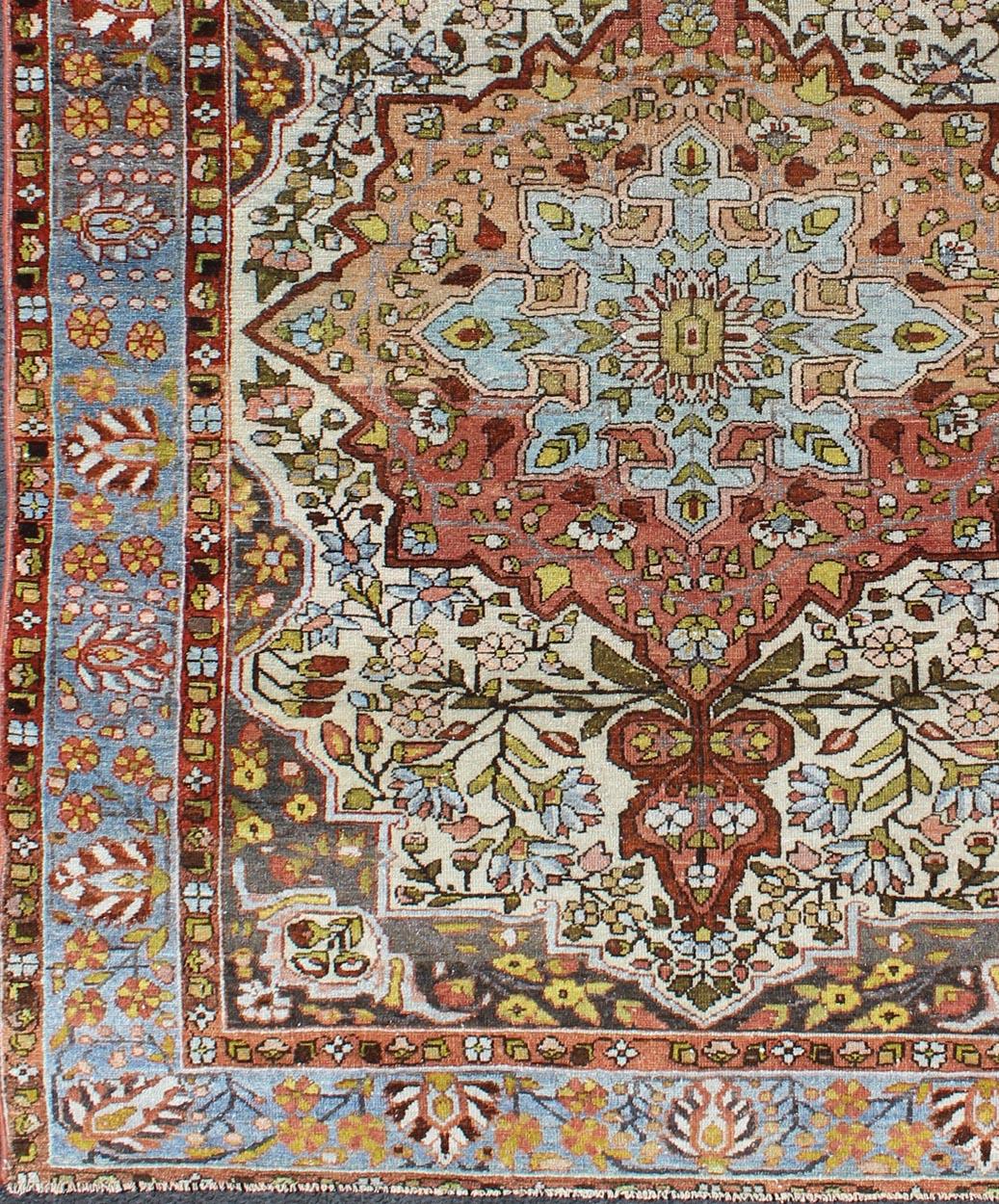 Multi-colors, burnt orange and ivory antique Persian Bakhtiari rug with floral medallion, rug gng-4757, country of origin / type: Iran / Bakhtiari, circa 1930s.

This antique multicolored Persian Bakhtiari rug from early 20th century Iran features a