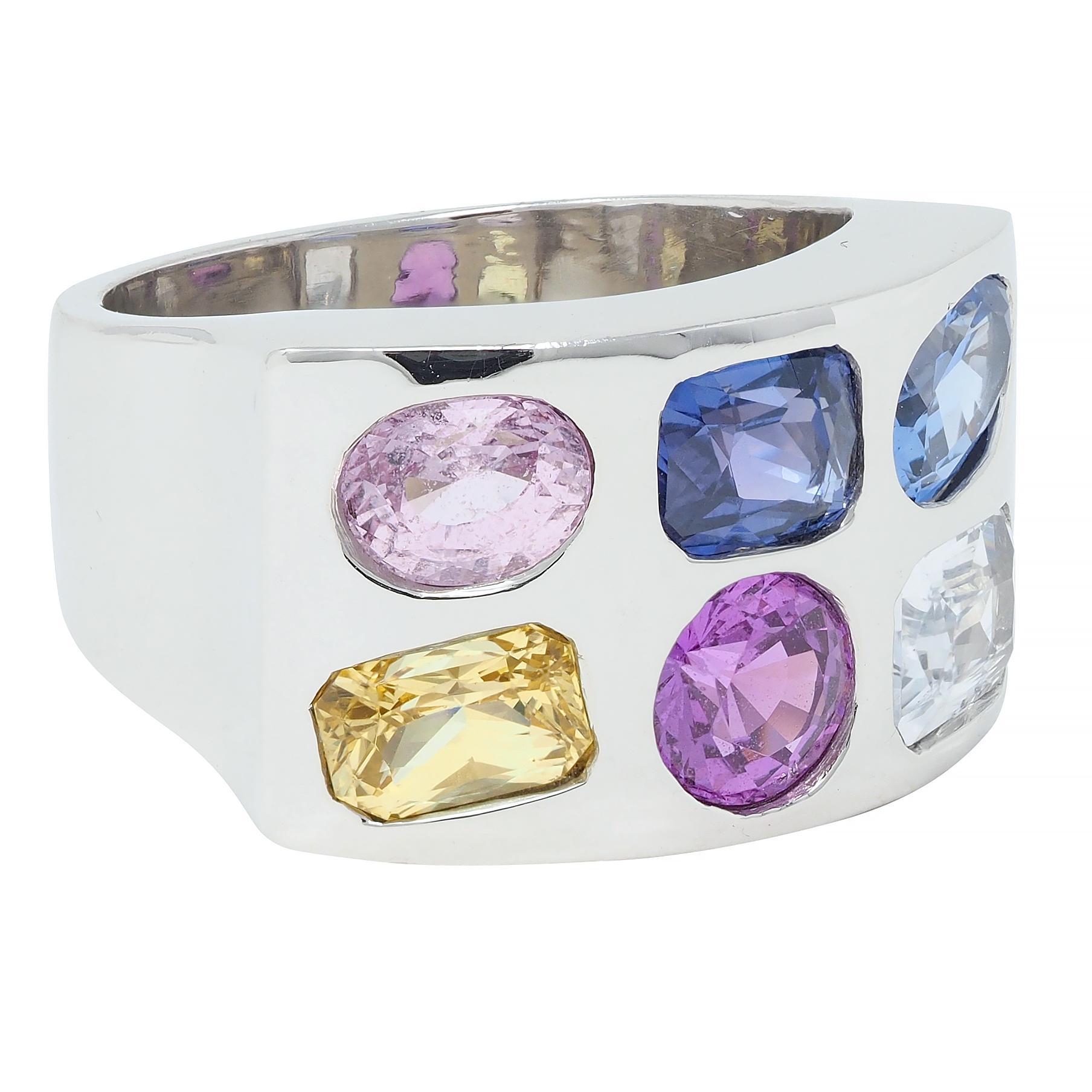 Designed as a rectangular form flush set with radiant, round, cushion, and oval cut sapphires 
Transparent white, light yellow, magenta, light pink, medium blue, and purple, respectively 
Weighing approximately 5.40 carats in total 
Competed by high