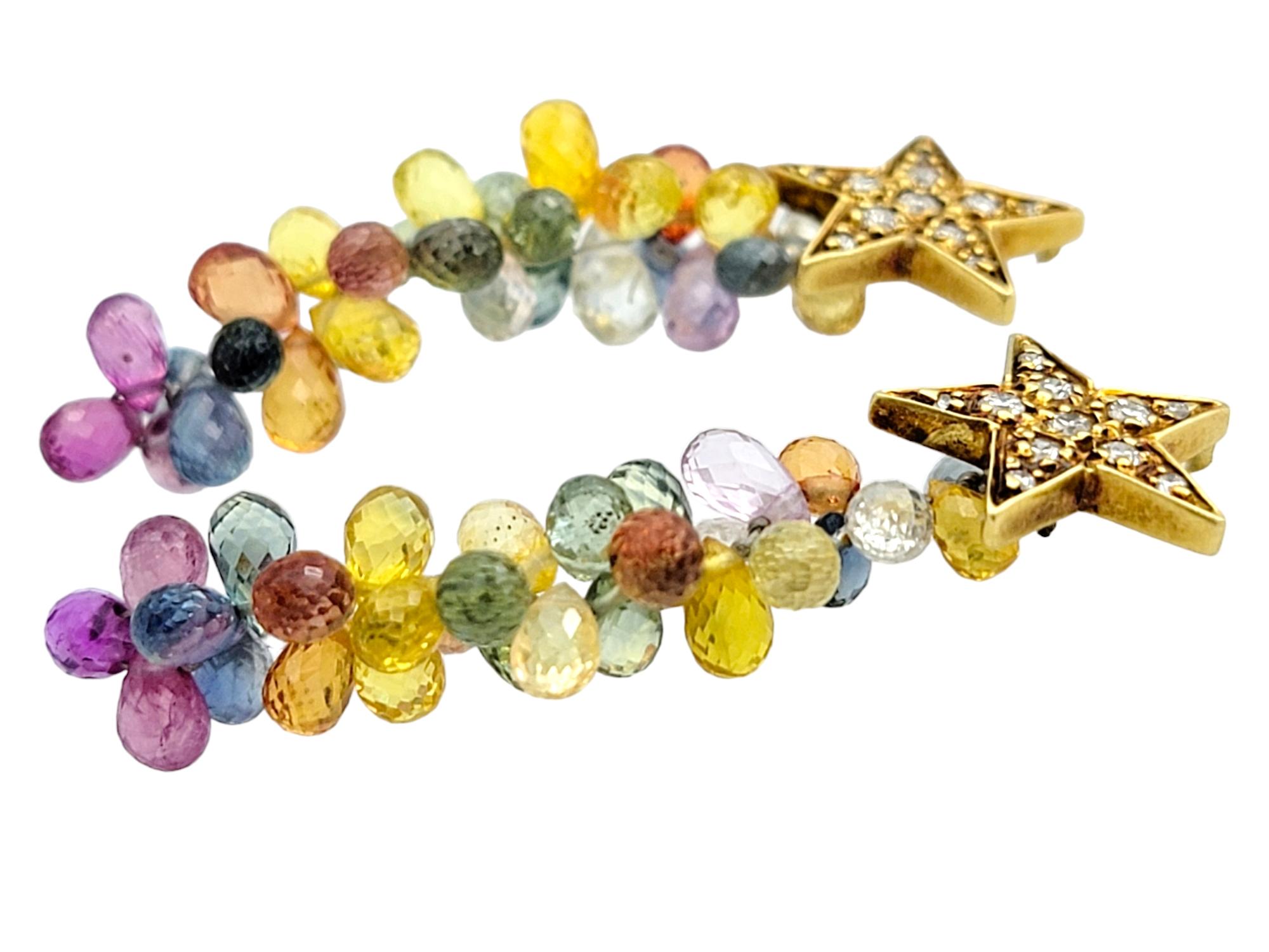 Shine like a star with these exquisite colored gemstone and diamond earrings, crafted in luxurious 18 karat yellow gold. At the top, a delicate star shape, encrusted with sparkling diamonds, captures the light brilliantly. From the star, a cascade