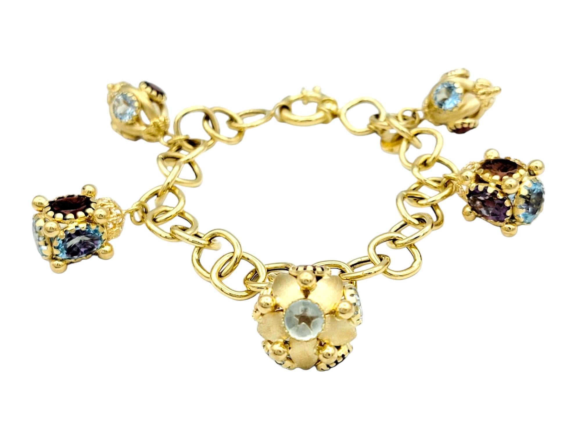 This enchanting charm bracelet, crafted in radiant 18 karat yellow gold, is a celebration of unique elegance. The chunky chain imparts a bold and contemporary feel, providing a sturdy foundation for the eclectic assortment of charms. The bracelet