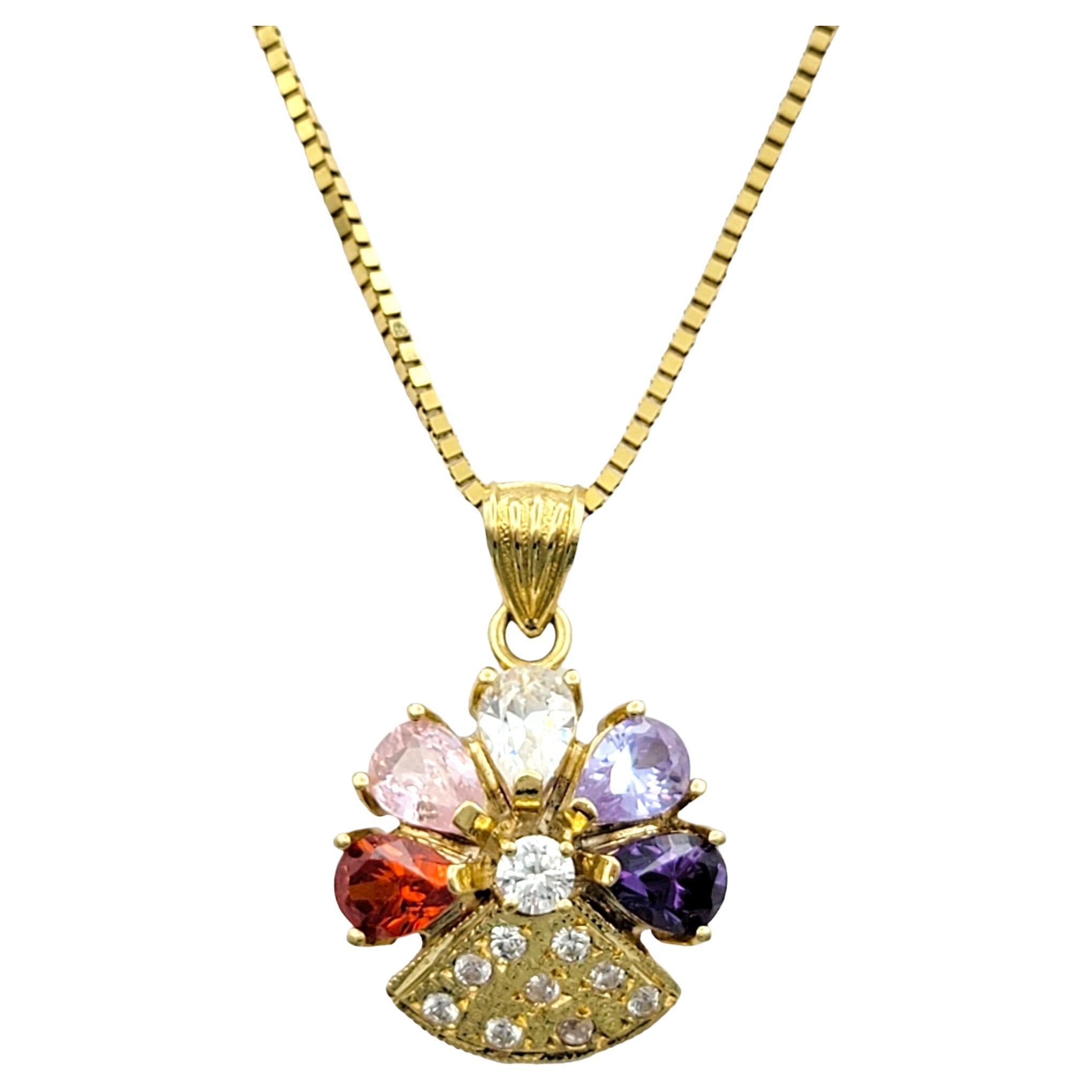 Elevate your style with our exquisite flower pendant necklace, paired with a delicate Unoaerre box chain, crafted in luxurious 18 karat yellow gold. The stunning flower-shaped pendant showcases vibrant petal gemstones, each petal radiating a unique