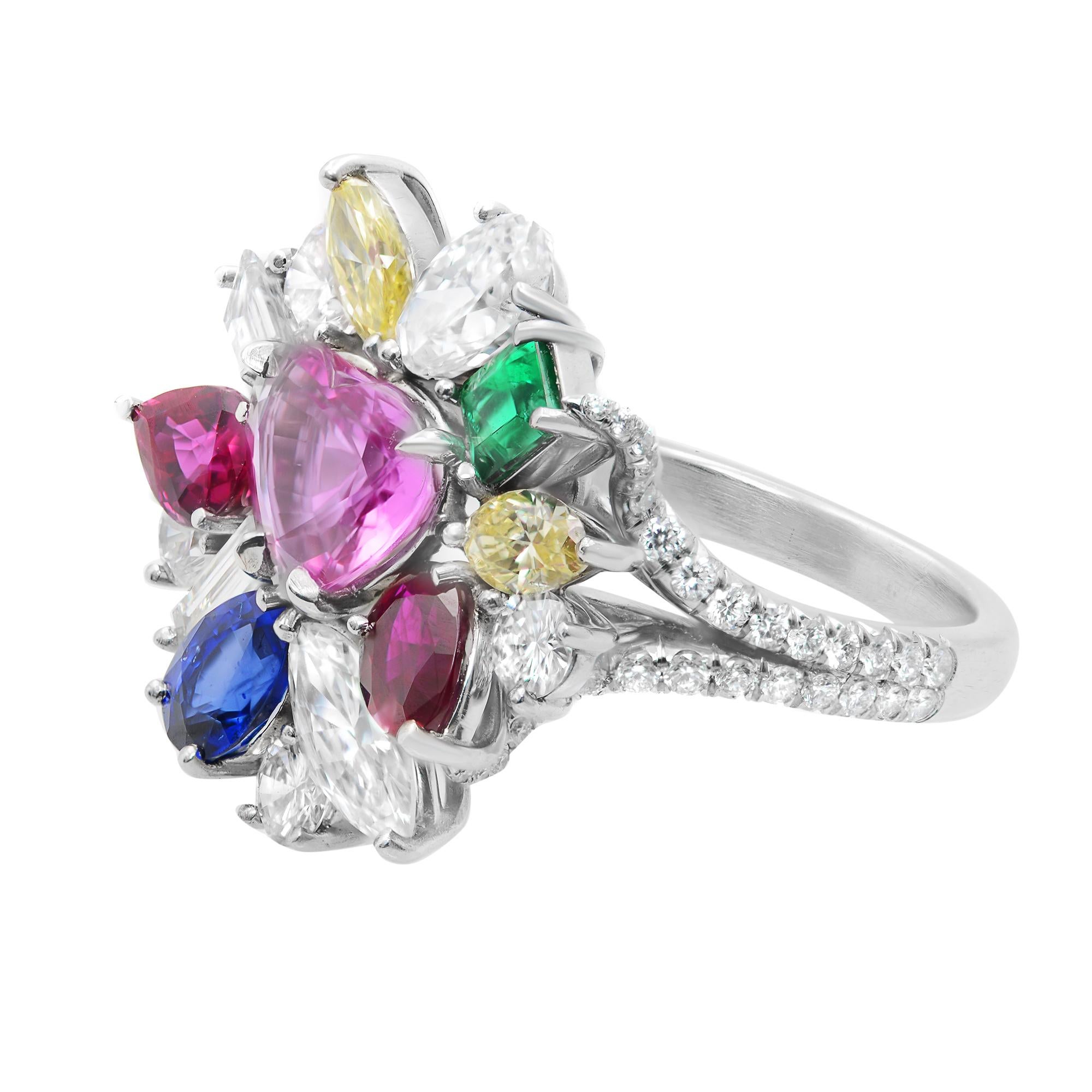 This multi colored gemstone cocktail ring features a cluster of different gemstones in a decorative spray pattern set in Platinum. Total number of stones used: 231. Featuring a stunning collection of gemstones like Emerald, Sapphire, Ruby, white