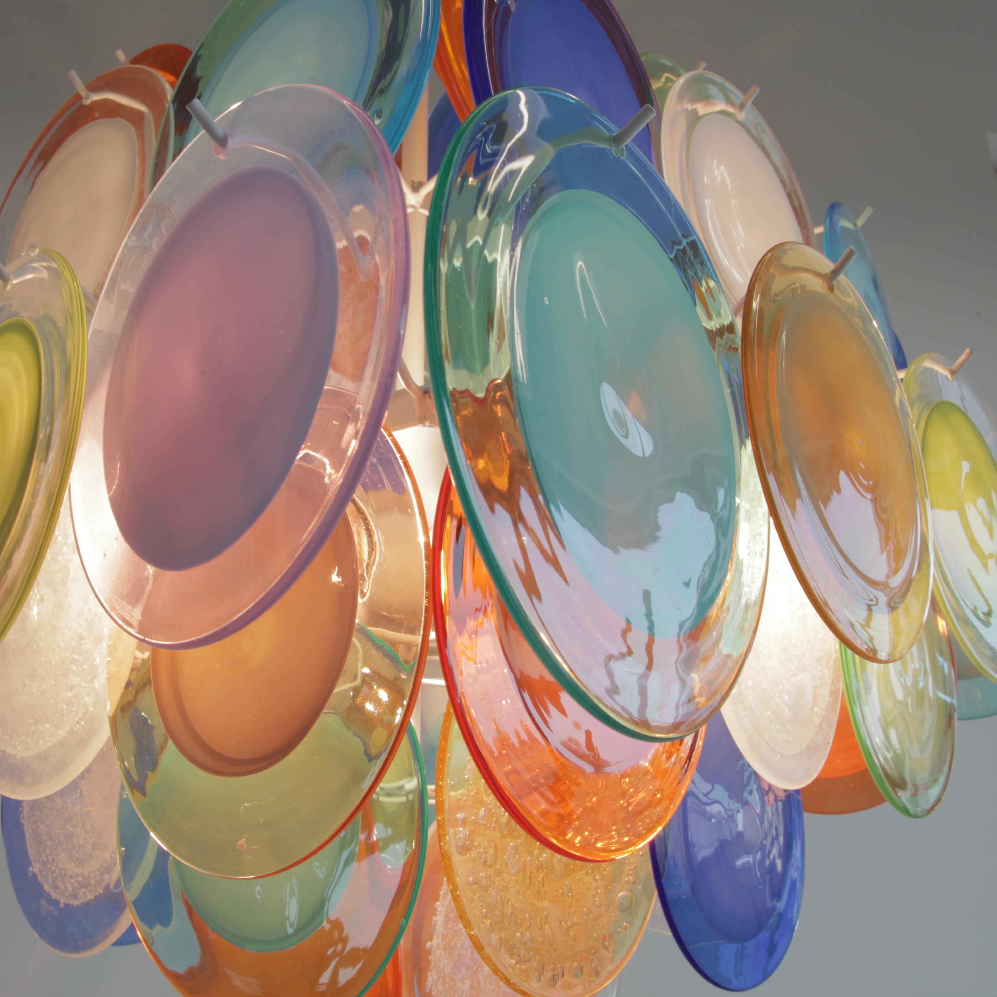 Large Vistosi glass disk chandelier. Italy, Murano, 1980's.

Chandelier with 64 multi-coloured glass disks, hand-made in Murano. White metal frame with ten E27 light sockets.
Condition:  

Excellent condition.
