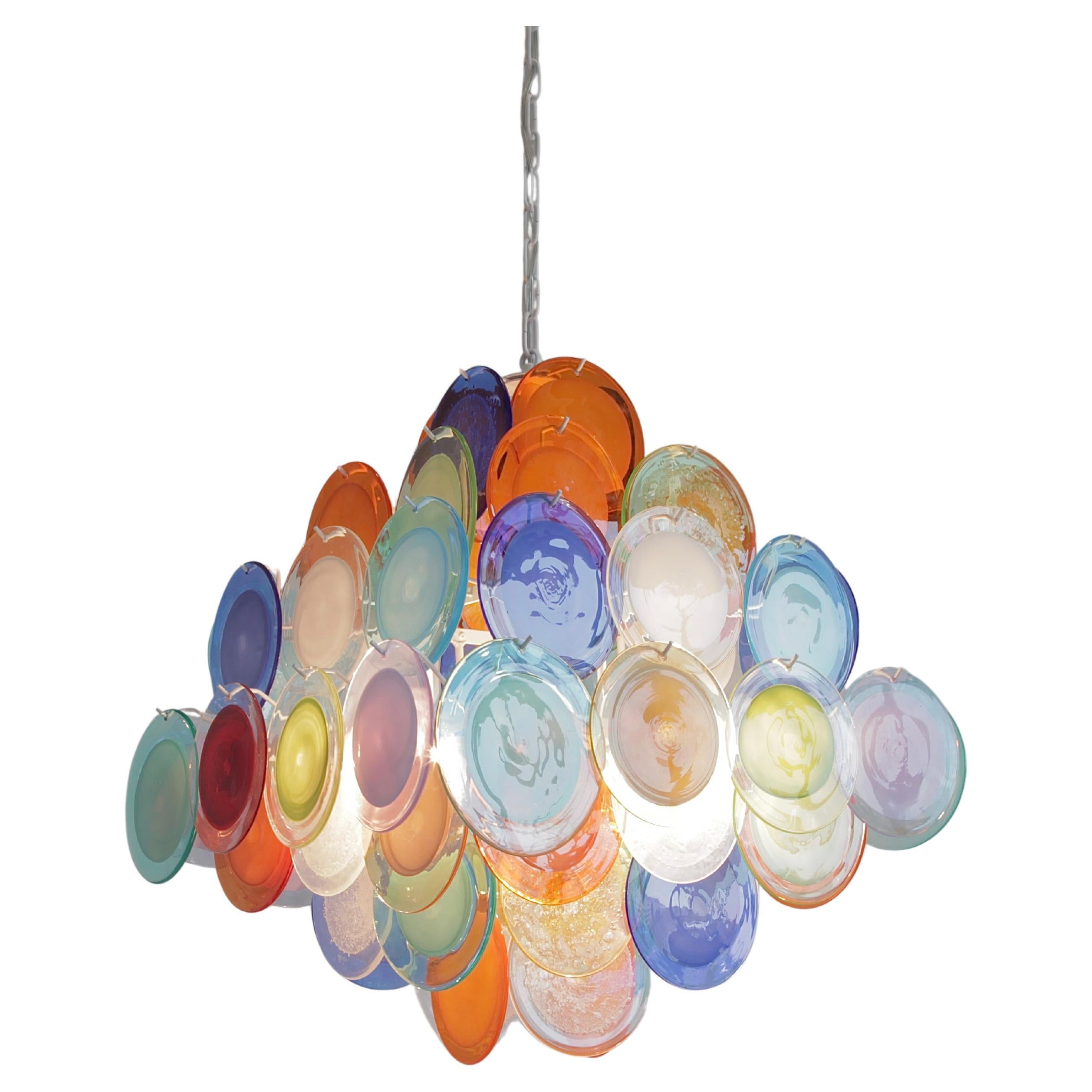 Large Vistosi glass disk chandelier. Italy, Murano, 1980's.

Chandelier with 64 multi-coloured glass disks, hand-made in Murano. White metal frame with ten E27 light sockets.
Condition:  

Excellent condition.
