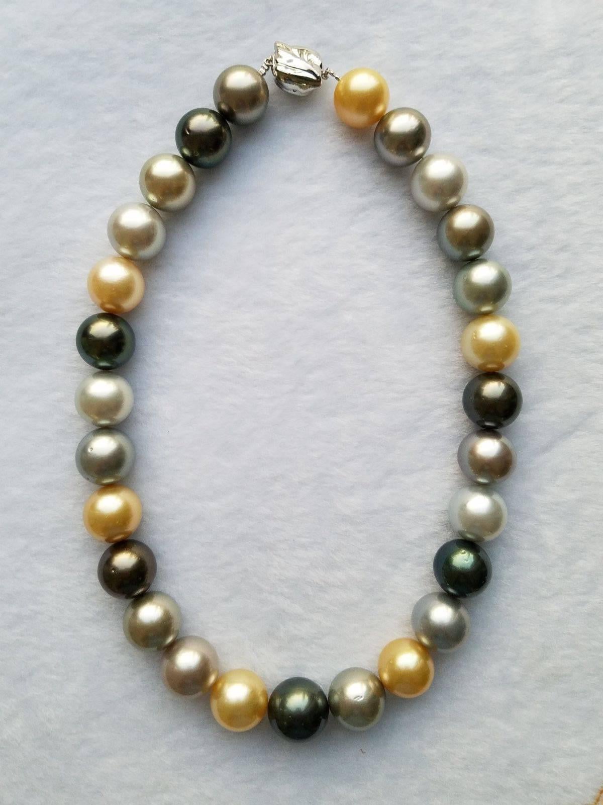 A very elegant strand of 27 multi-coloured natural south sea pearls, ranging from 15 to 17mm in diameter, with a total weight of 42.5 momme. Strung on hand knotted silk cord, this necklace has a silver/gold clasp (which can be change depending on