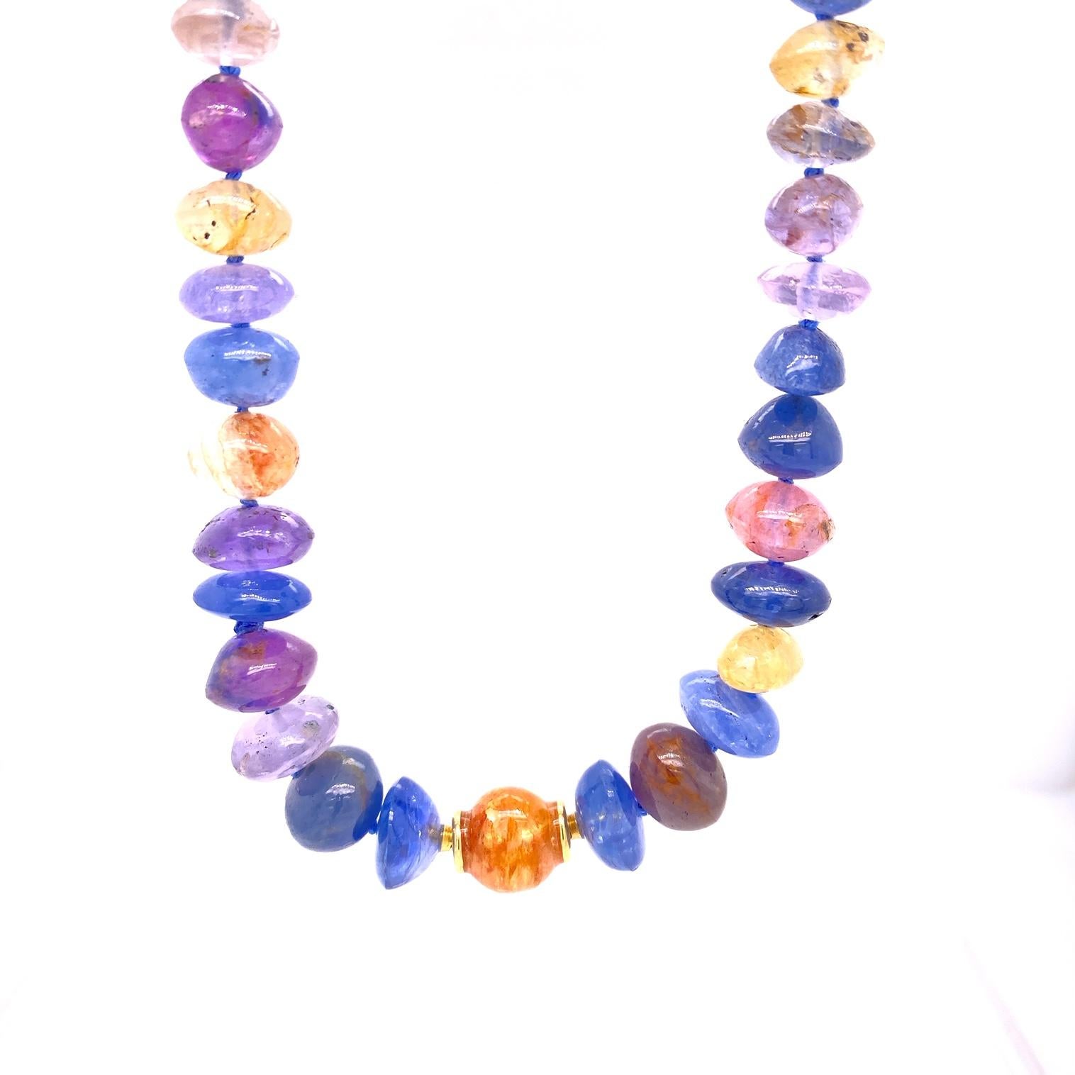 A 220 carat free-form rondell Multi-colored sapphire strand with 18k yellow gold  modullyn parts. This necklace is 19.5 inches long, with an 18k rose gold 