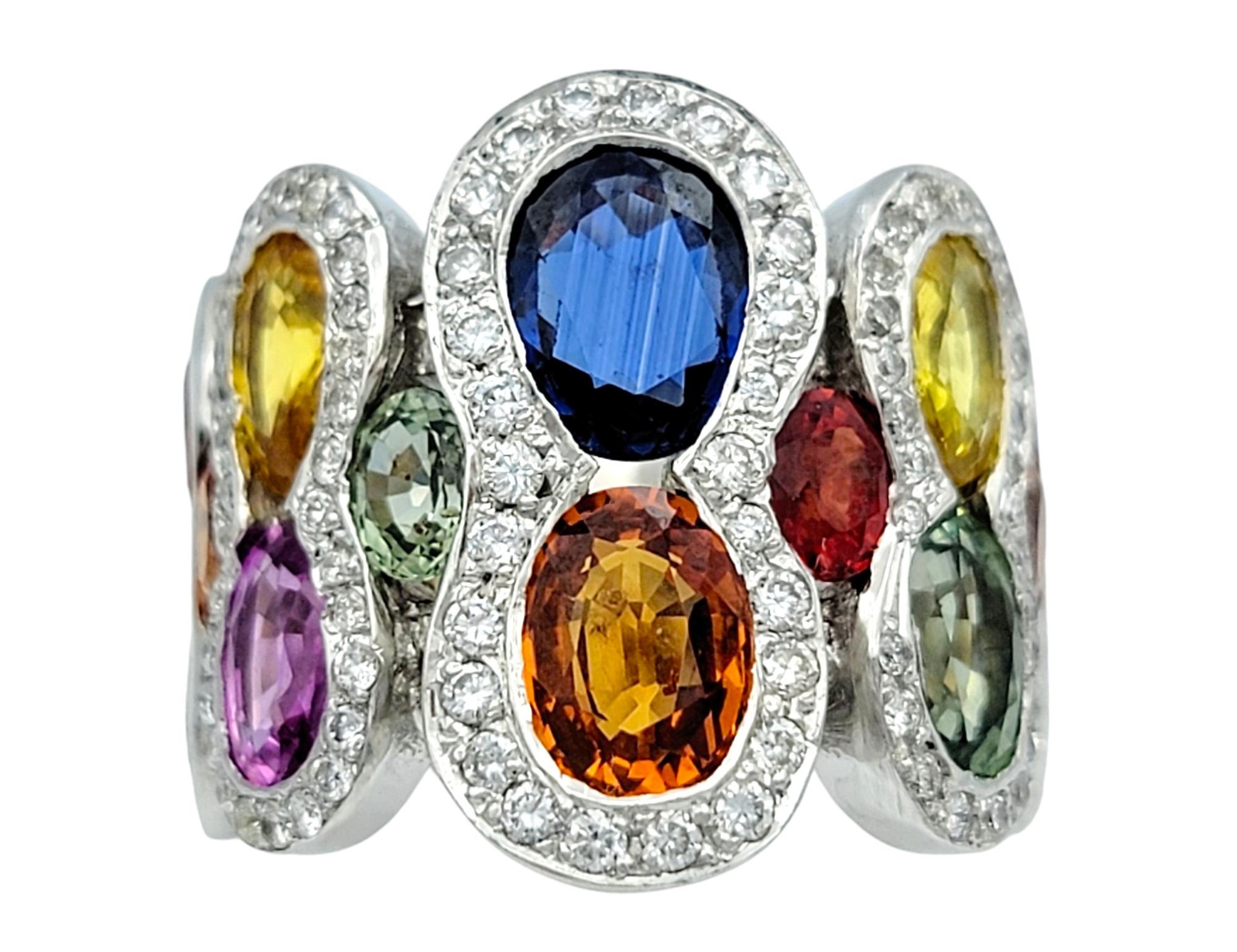 Ring size: 5

Embrace a vibrant symphony of color with this extraordinary multi-colored sapphire ring, a true masterpiece of artistry and luxury. Set in 18 karat white gold, this wide-band ring features an array of stunning sapphires in a rainbow of