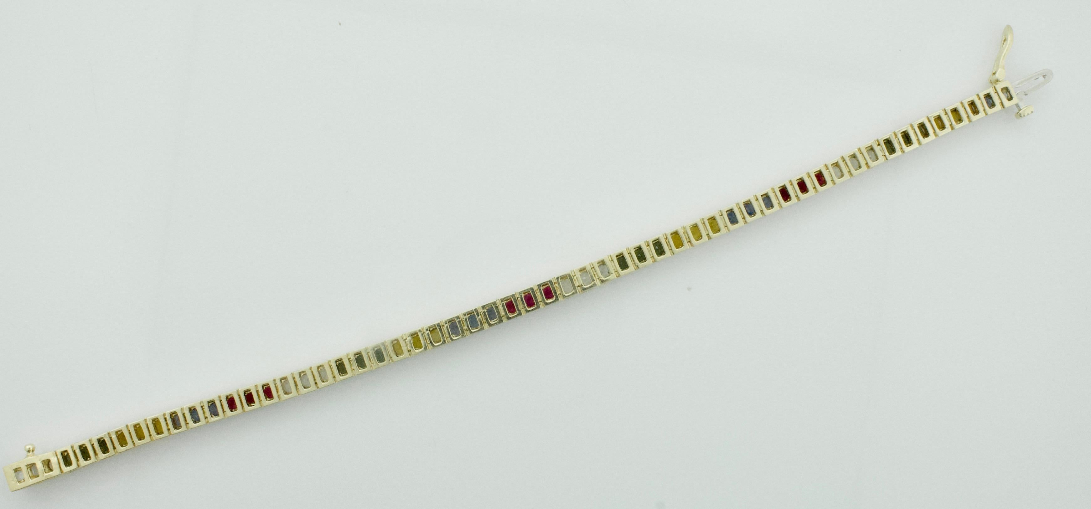 Multi - Colored Sapphire and Ruby Tennis Bracelet in Yellow Gold
Fifty Six Round Princess Cut Multi - Colored Sapphires and Rubies weighing 7.50 carats approximately [bright with no imperfections visible to the naked eye] Seven Inches in Length 