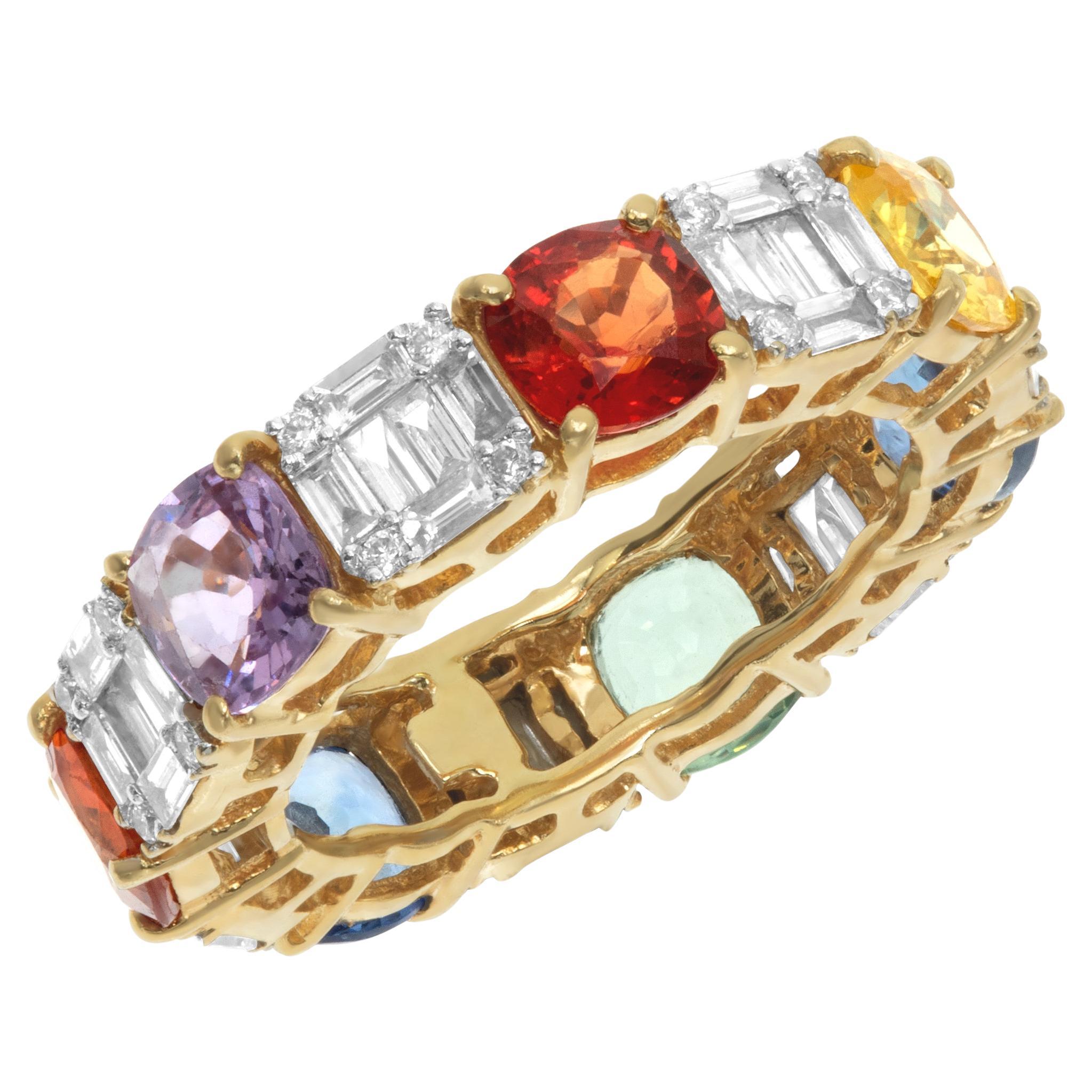 Multi-colored sapphires eternity band in yellow gold.