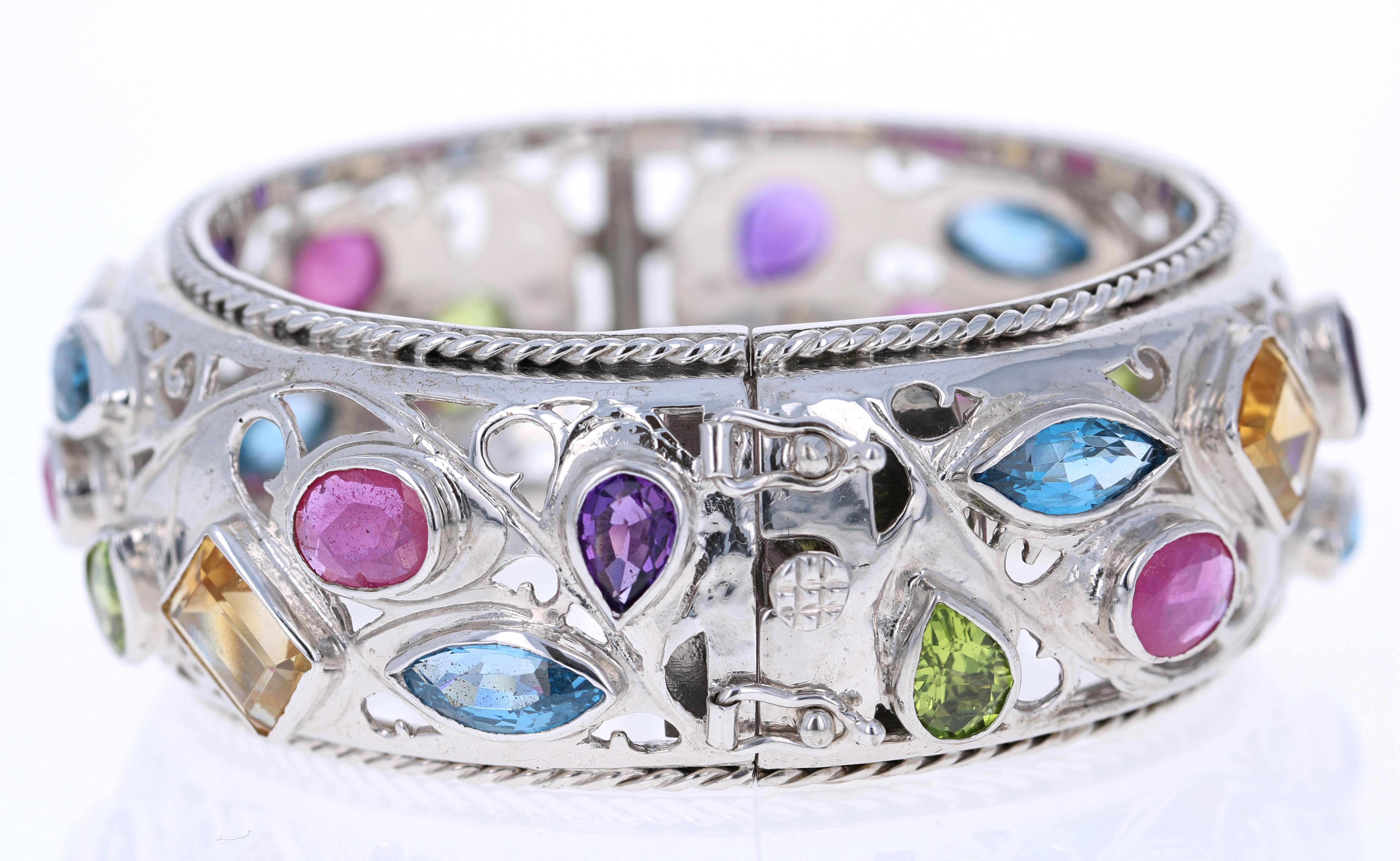 Diese Multi Colored Stone Bangle hat Oval, Pear, Emerald & Marquise Cut Steine, die echte Amethyste, Blue Topaz, Granate, Peridot und Citrin sind. 

Der Armreif ist handgefertigt in 925 Silber. 

Ob schick oder leger - er ist ein echter Hingucker! 