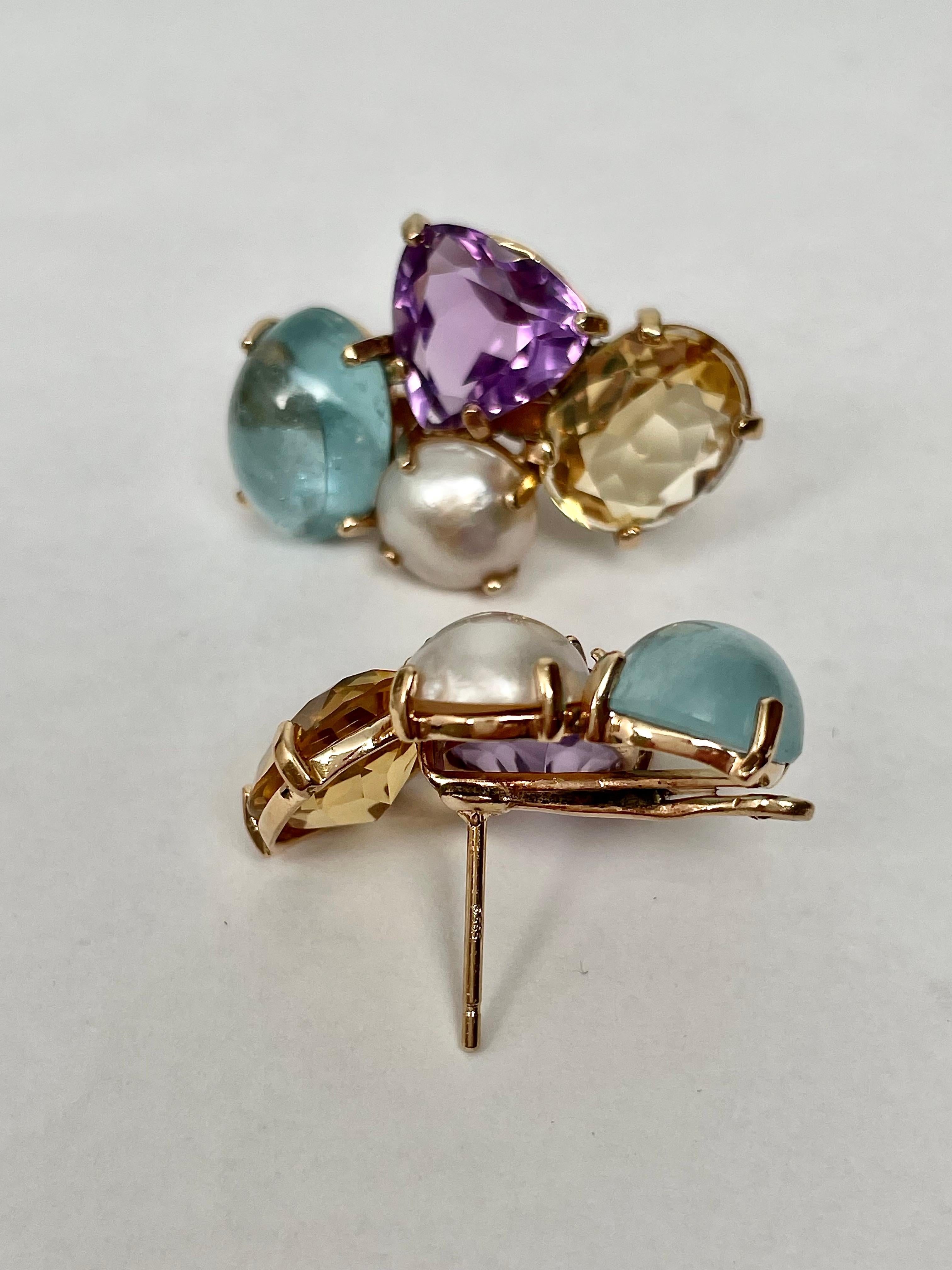 Custom made in 14kt. Yellow Gold  the Amethysts, Aquamarines, Citrines and Mabe Pearls are the focus of this multi-colored pair of earrings! The cluster of large gemstones are reminiscent of glamorous stars of the 1960's because they are actually