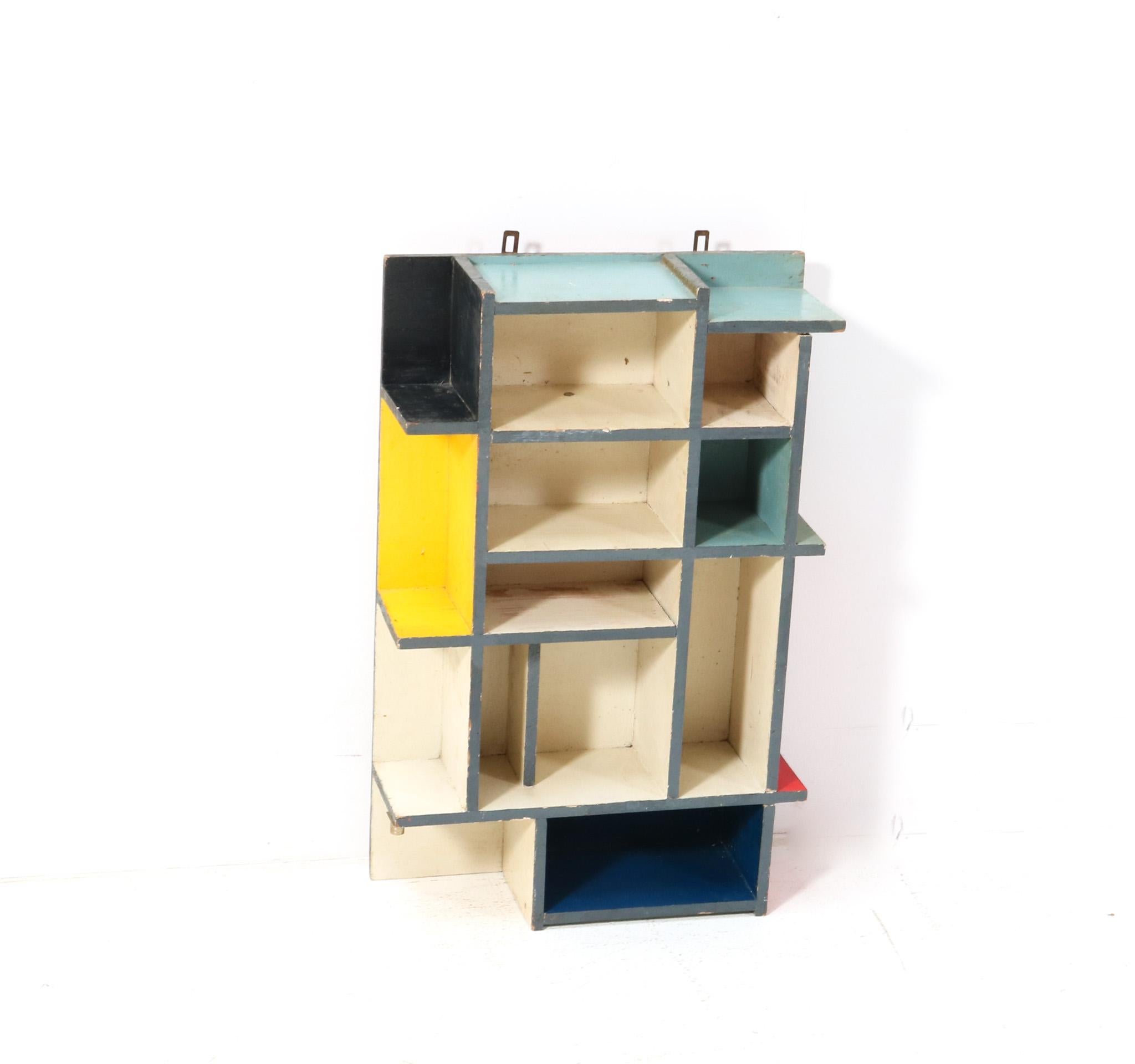 Stunning and rare Art Deco Modernist De Stijl wall cabinet.
Striking Dutch design from the 1940s.
Original hand-painted plywood frame in the typical De Stijl colors.
In very good original condition with minor wear consistent with age and use,