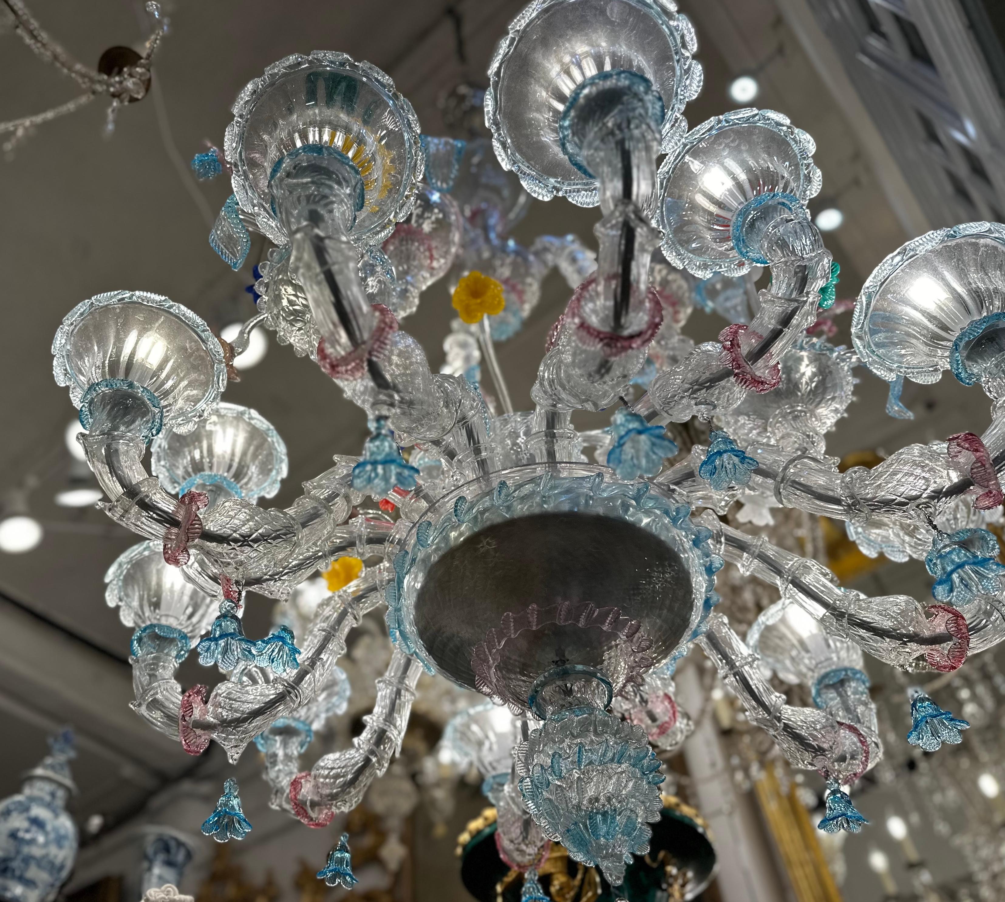 A breathtaking multi-coloured murano glass hand blown chandelier with floral design. Murano glass is world renown, with a long history spanning centuries. Popular with aristocrats, celebrities and interior designers throughout the world it has a