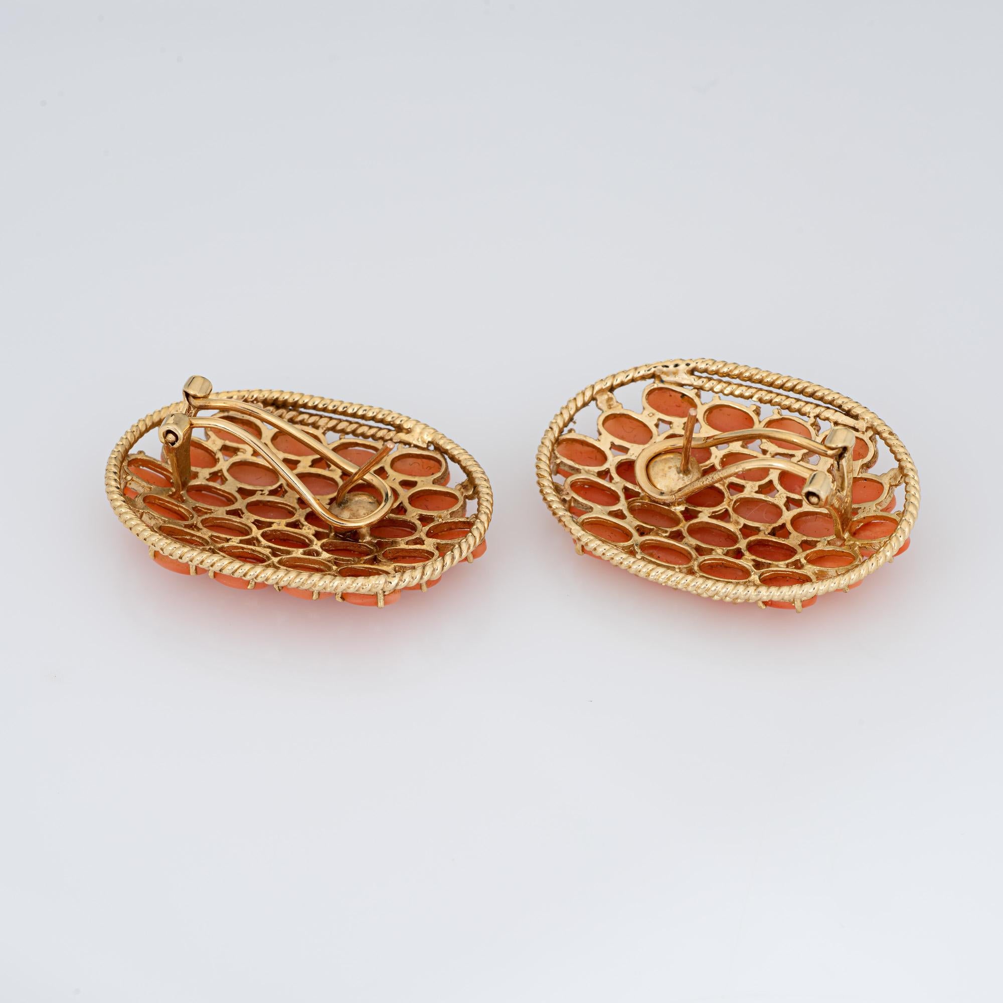 Stylish pair of vintage coral earrings crafted in 14k yellow (circa 1960s). 

Coral is uniform in size measuring 5mm x 3mm (0.20 carats each - 9.60 carats total estimated weight).  

Large in scale measuring 1.25 x 0.90 inches, the earrings make a