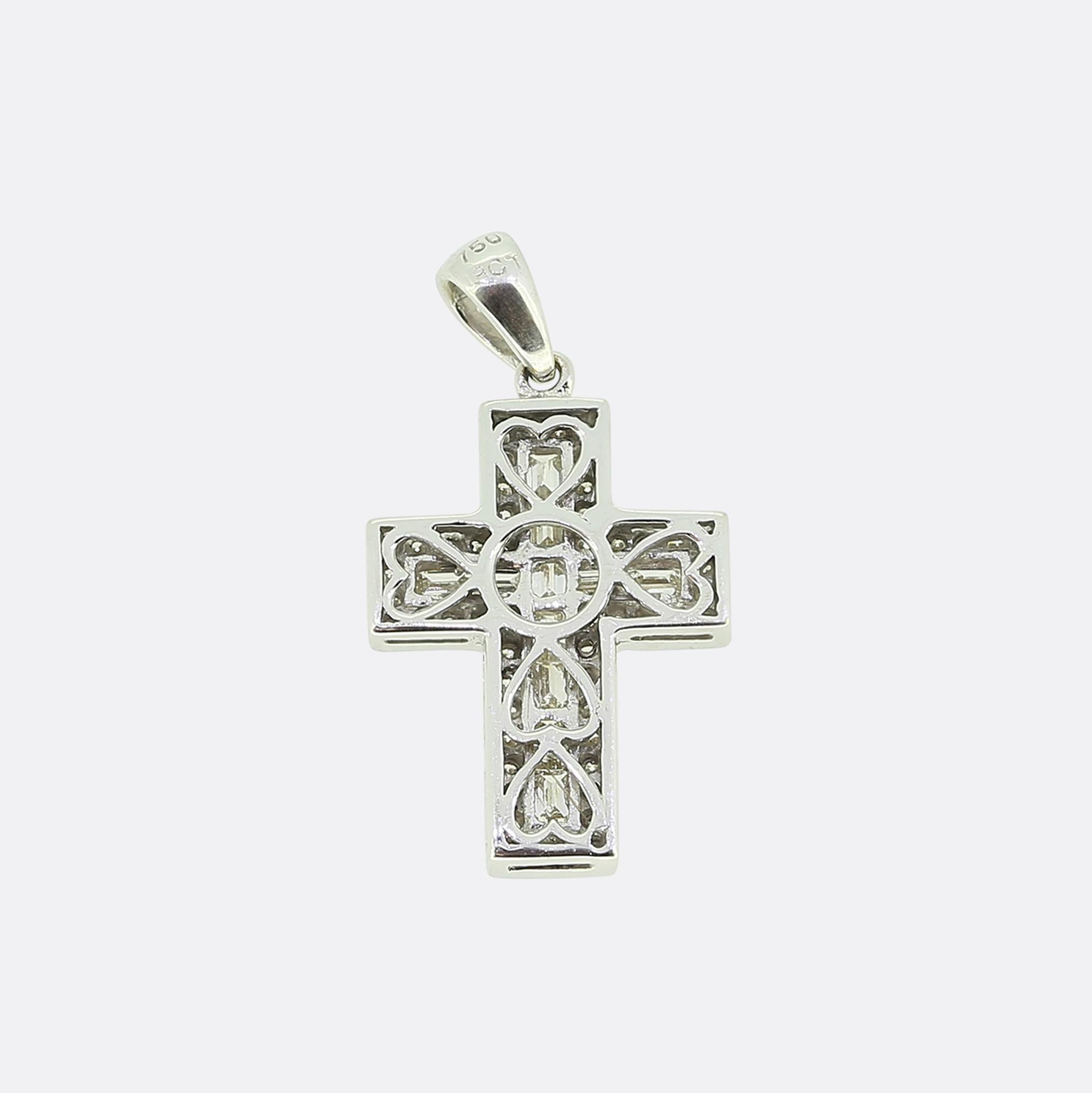 Here we have a stylish cross pendant. Crafted in 18ct white gold, this piece showcases a classic cross design adorned with both baguette and brilliant-cut diamonds. The central cross is lined with straight baguette-cut diamonds, creating a sleek and