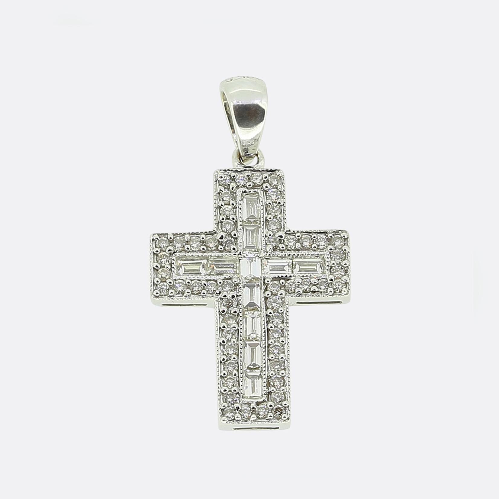 Here we have a stylish cross pendant. Crafted in 18ct white gold, this piece showcases a classic cross design adorned with both baguette and brilliant-cut diamonds. The central cross is lined with straight baguette-cut diamonds, creating a sleek and