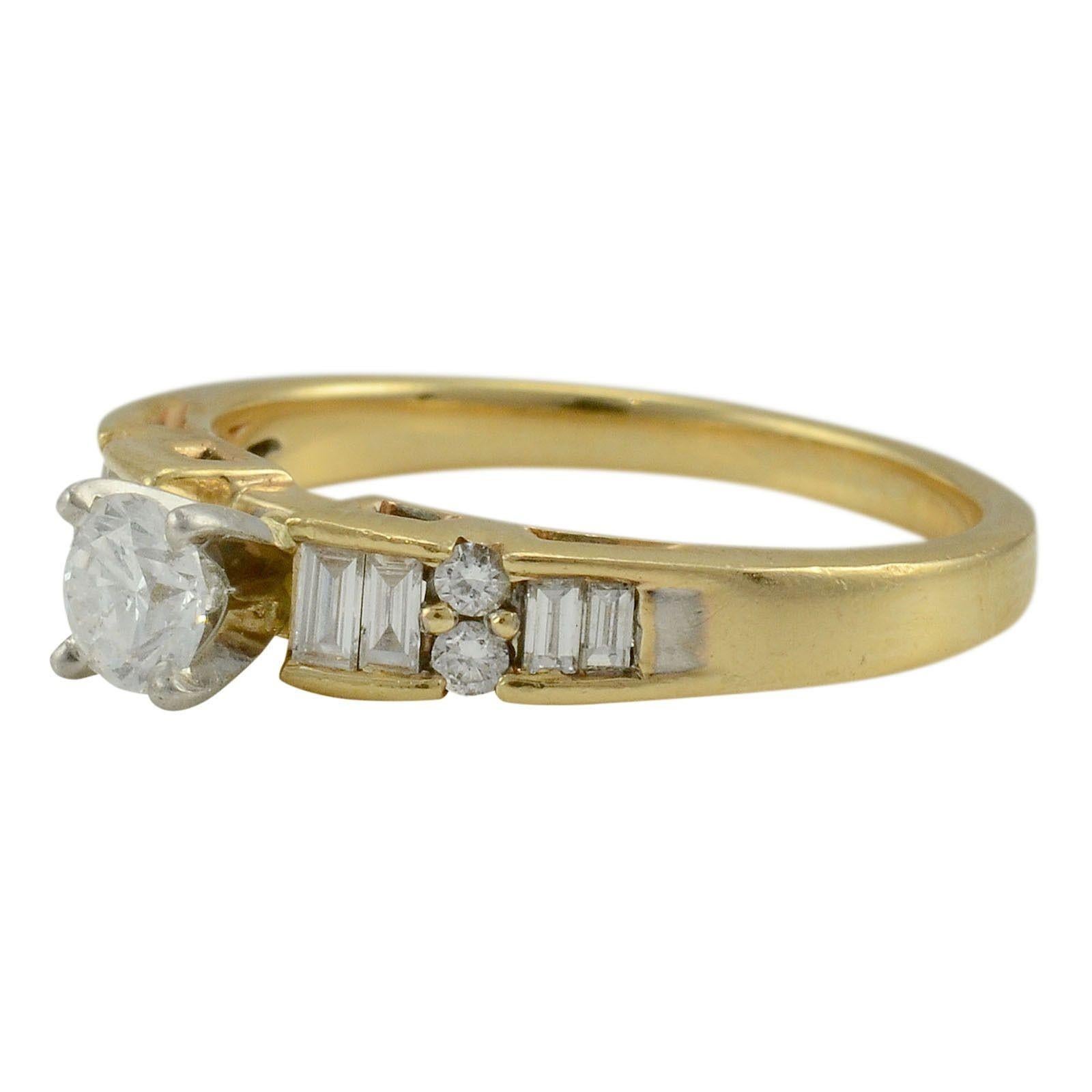 Estate 0.30 carat center diamond two tone gold engagement ring. This 14 karat white gold and yellow gold ring has a center round diamond that is 0.30 carats, SI1 clarity, G color, eight baguette diamonds and four full cut diamonds at 0.43 carat