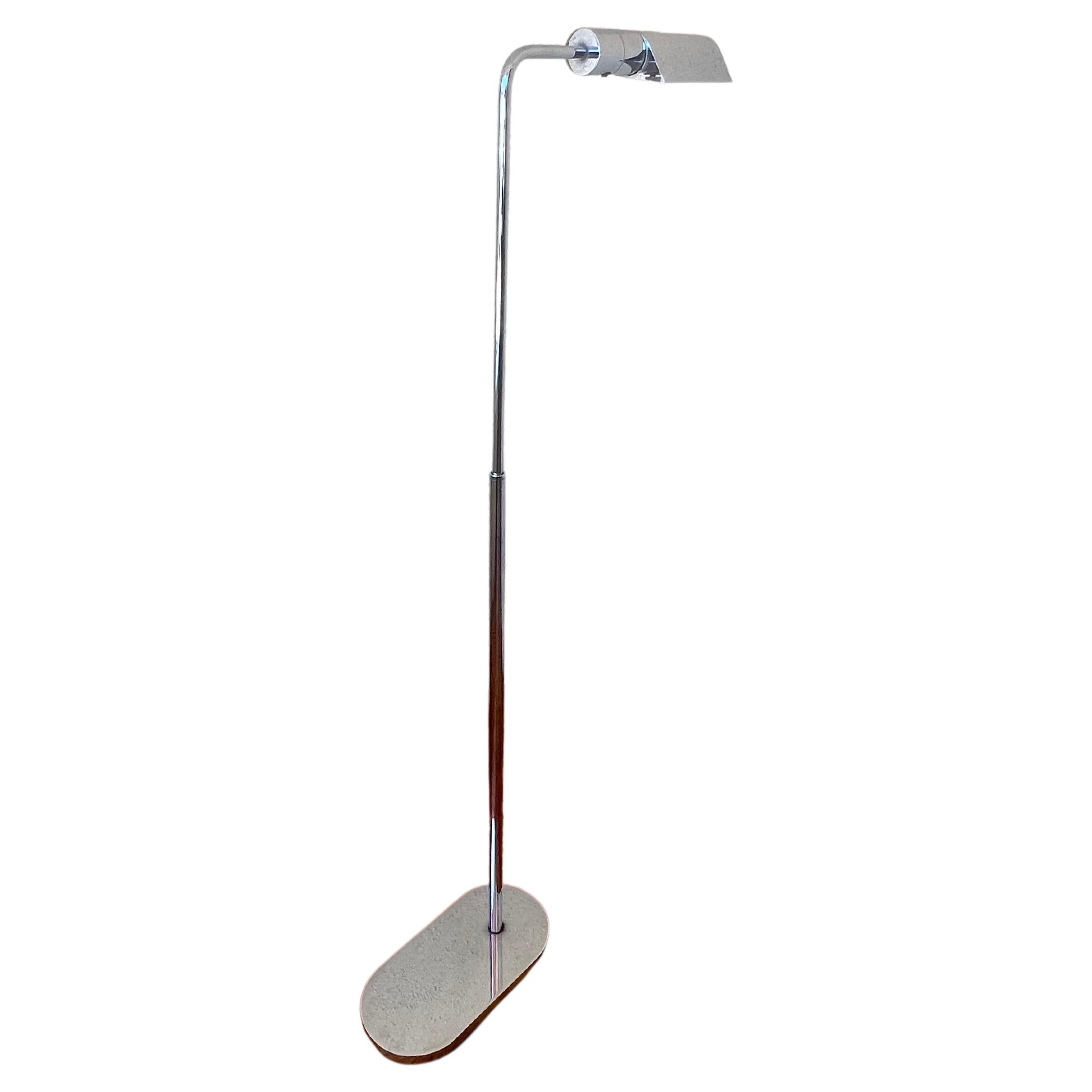 Elegant multi-Directional floor lamp by Casella Lighting of San Francisco. The main lamp pole moves up and down and rotates 360 degrees; the tubular shade also moves from side to side. The lamp, which has a dimmer switch, extends to 48