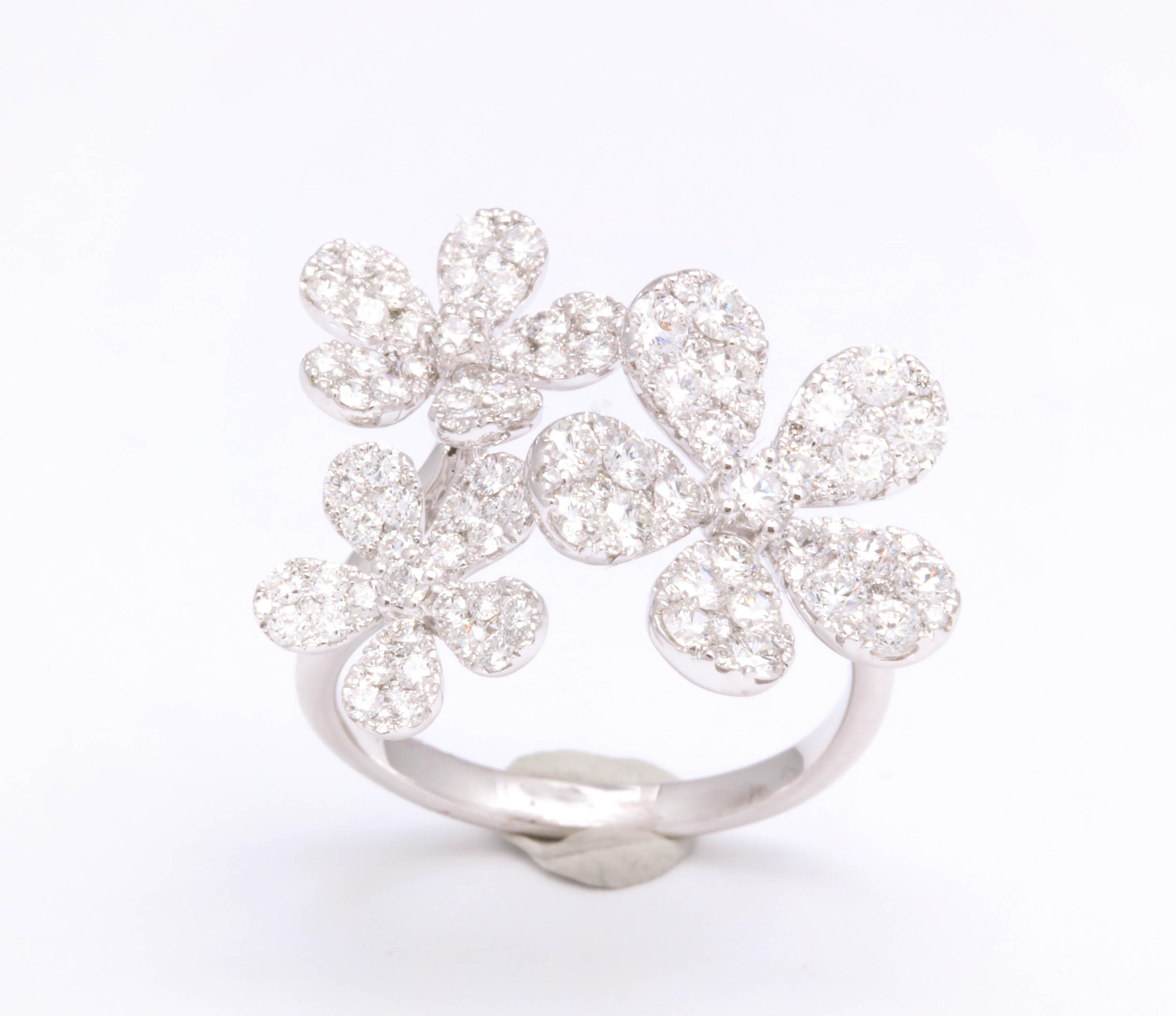 
Three 5 Petal Diamond Flower ring 

1.80 carats of white round brilliant cut diamonds set in 18k white gold.

The ring is currently a size 7,  but can be easily resized. 

A beautiful gift!!